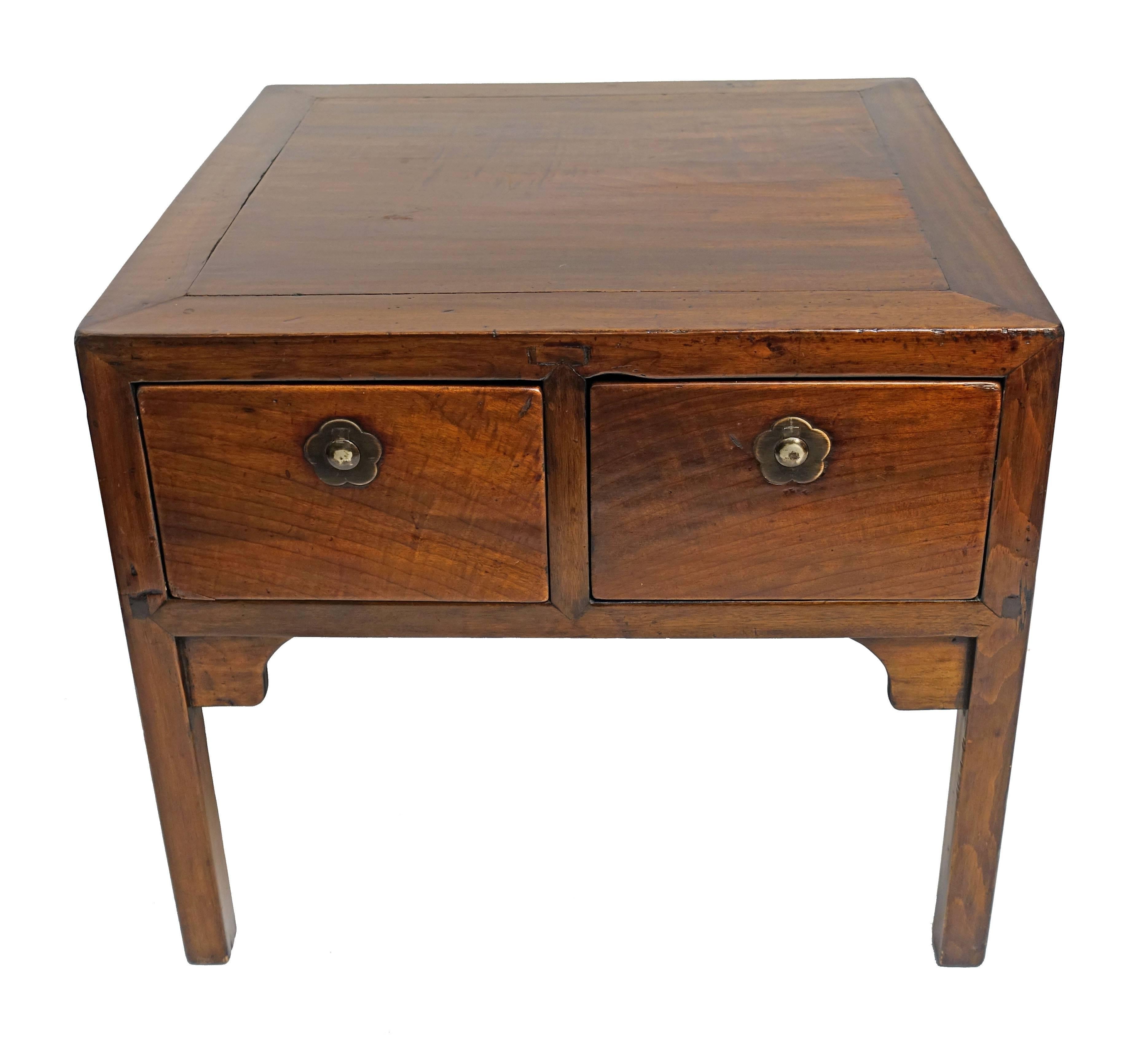 Low side table with two drawers, having unusual brass drawer pulls that lift up revealing a hidden lock. We do not have keys for this table, China, 19th century.
