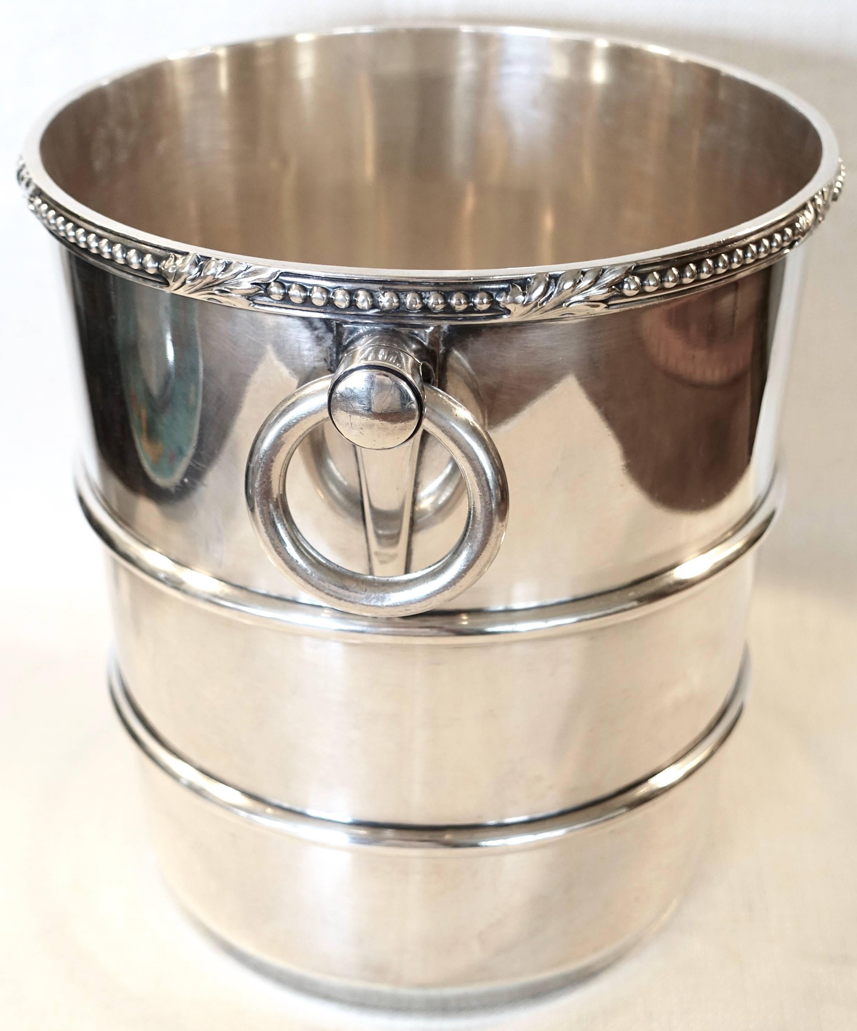Very nice restaurant silver plate champagne cooler ice bucket with a beaded and acanthus leaf border around the top and two ring handles with double ribs around the tapering body. A leaf chest with the monogram 