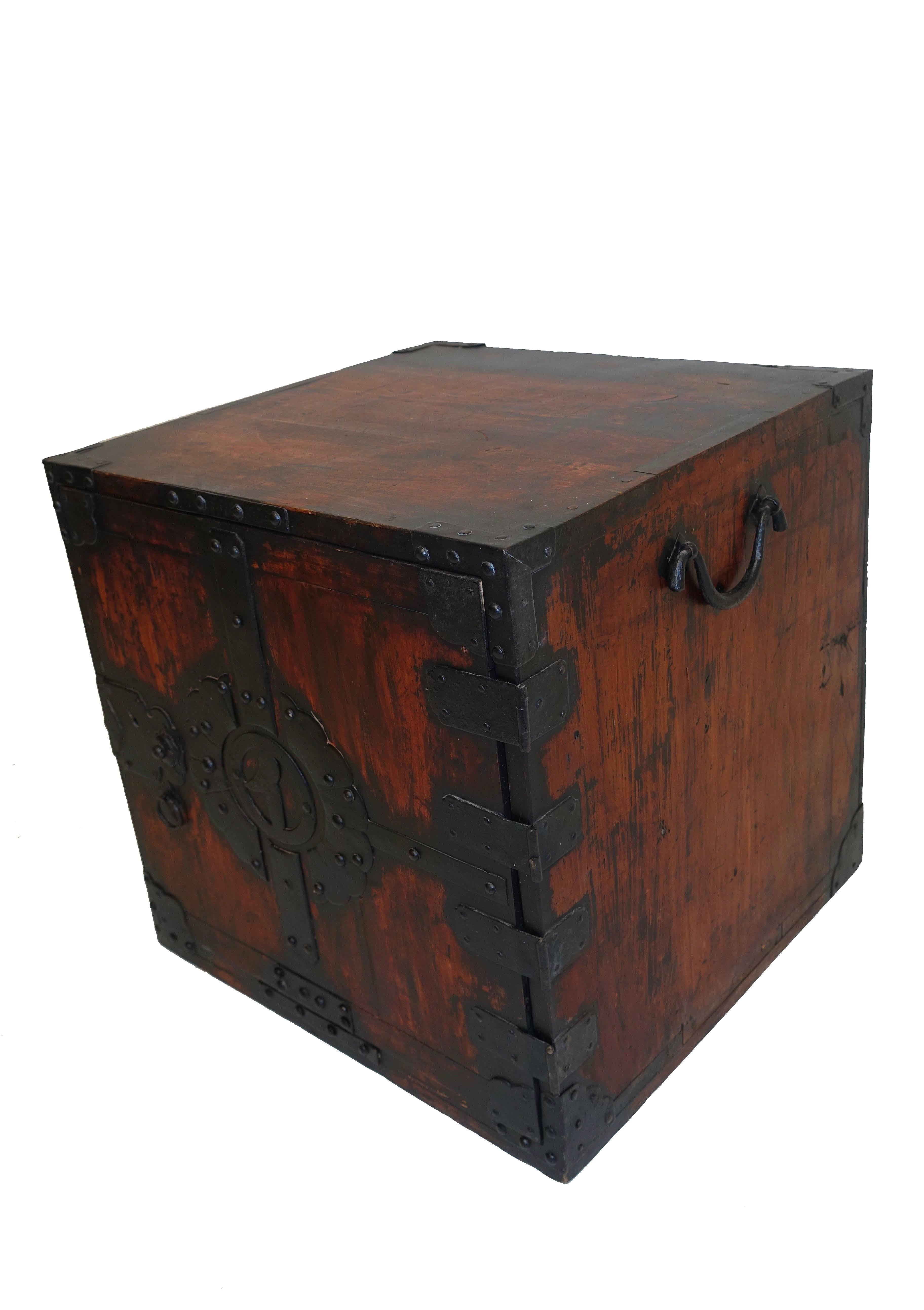 Small shipboard chest with iron decoration and fitted interior. Elaborate iron detail on the door, opening to a single long drawer over two short drawers above a single long drawer, with iron handles, Japan, 19th century.

This type of heavy chest