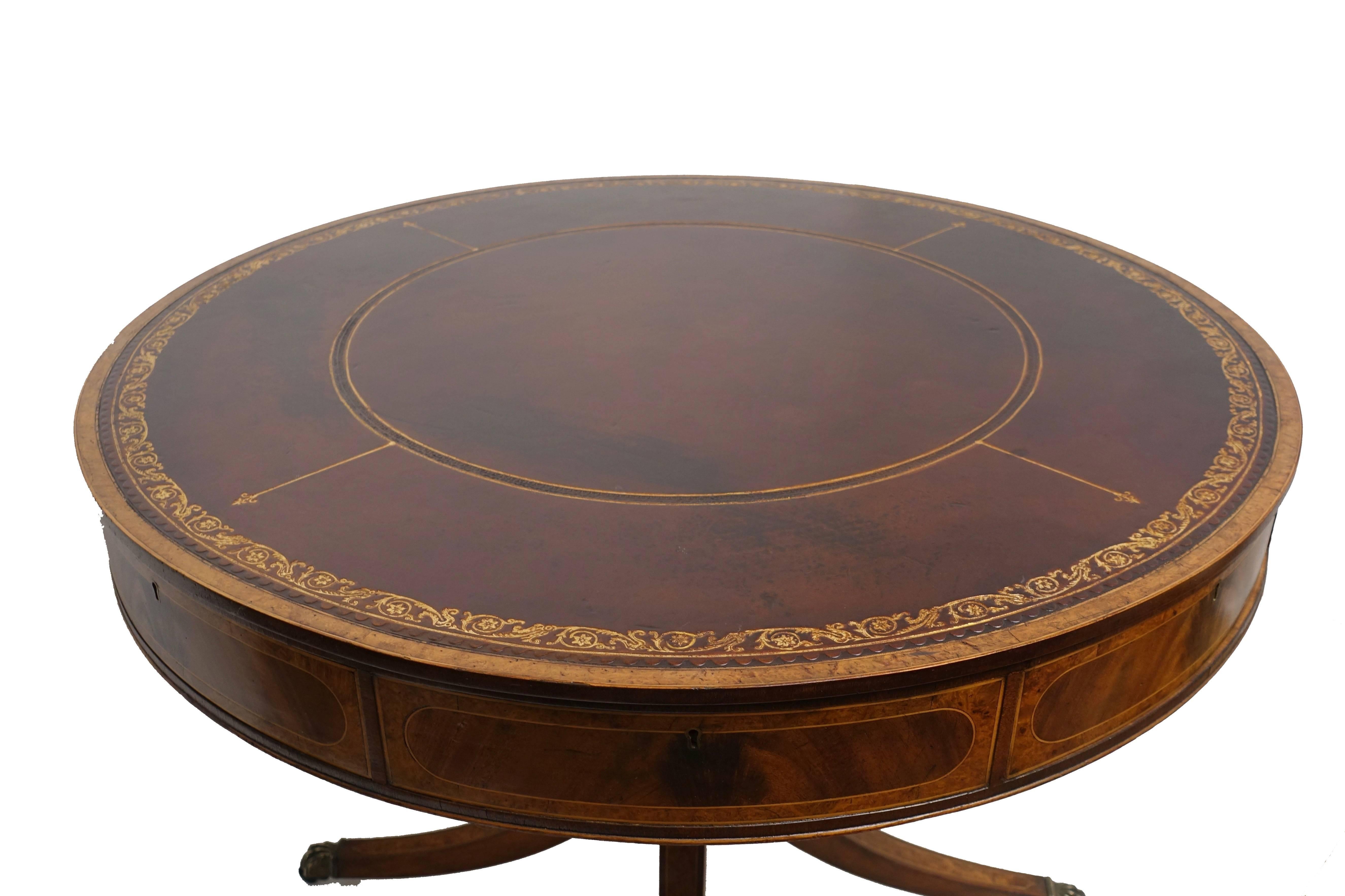 Handmade mahogany rent table or library/centre table with original inset leather surface having hand tooled gilt edge detail. Table has four working drawers and four blind drawers, standing on an elegant four legged pedestal base. Recently