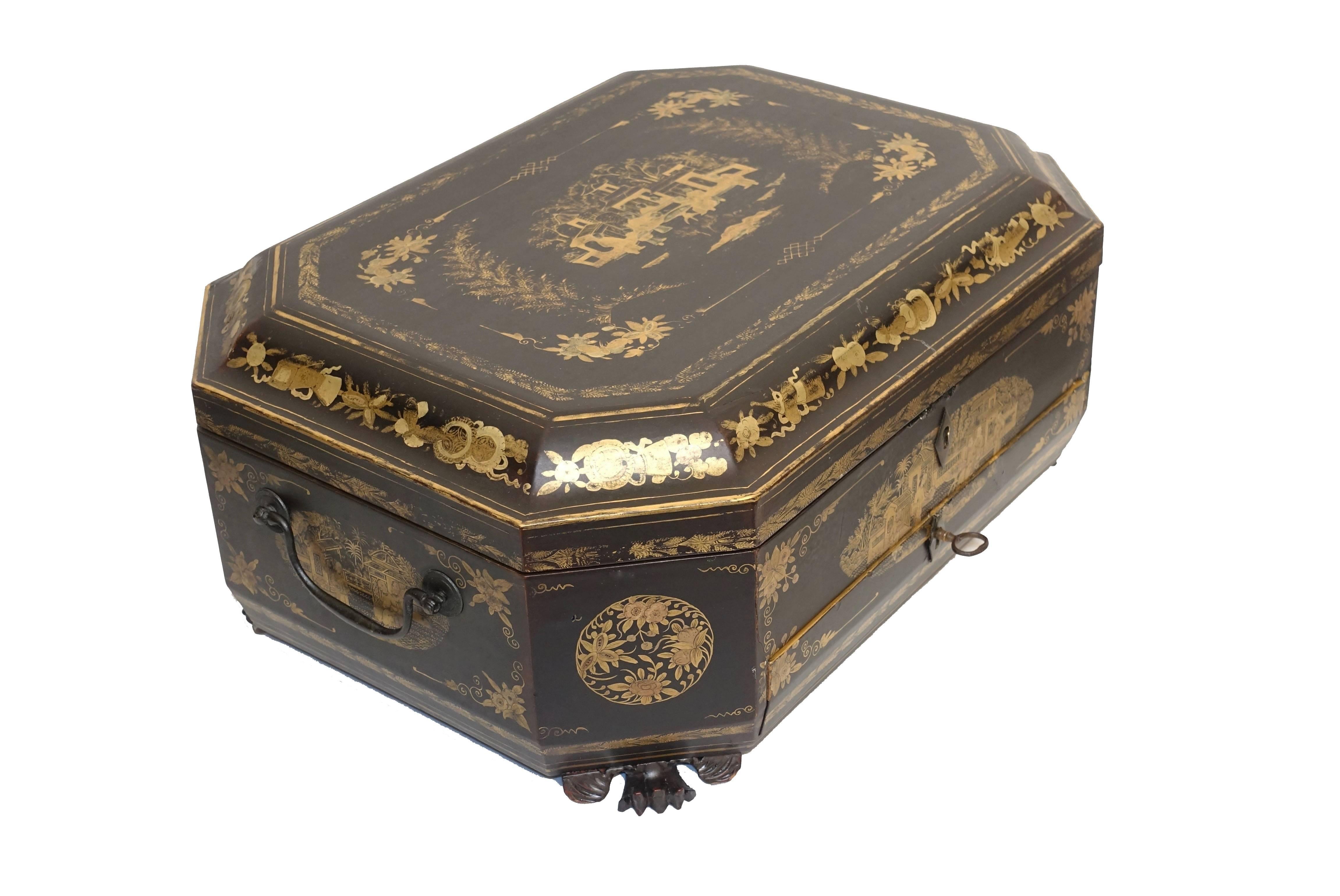 Chinoiserie decorated gilt and lacquer sewing box made for the export market. The interior fitted with divided pull-out shell, and a single drawer with divided sections. Standing on the original dragon paw feet and having a working key. China, circa