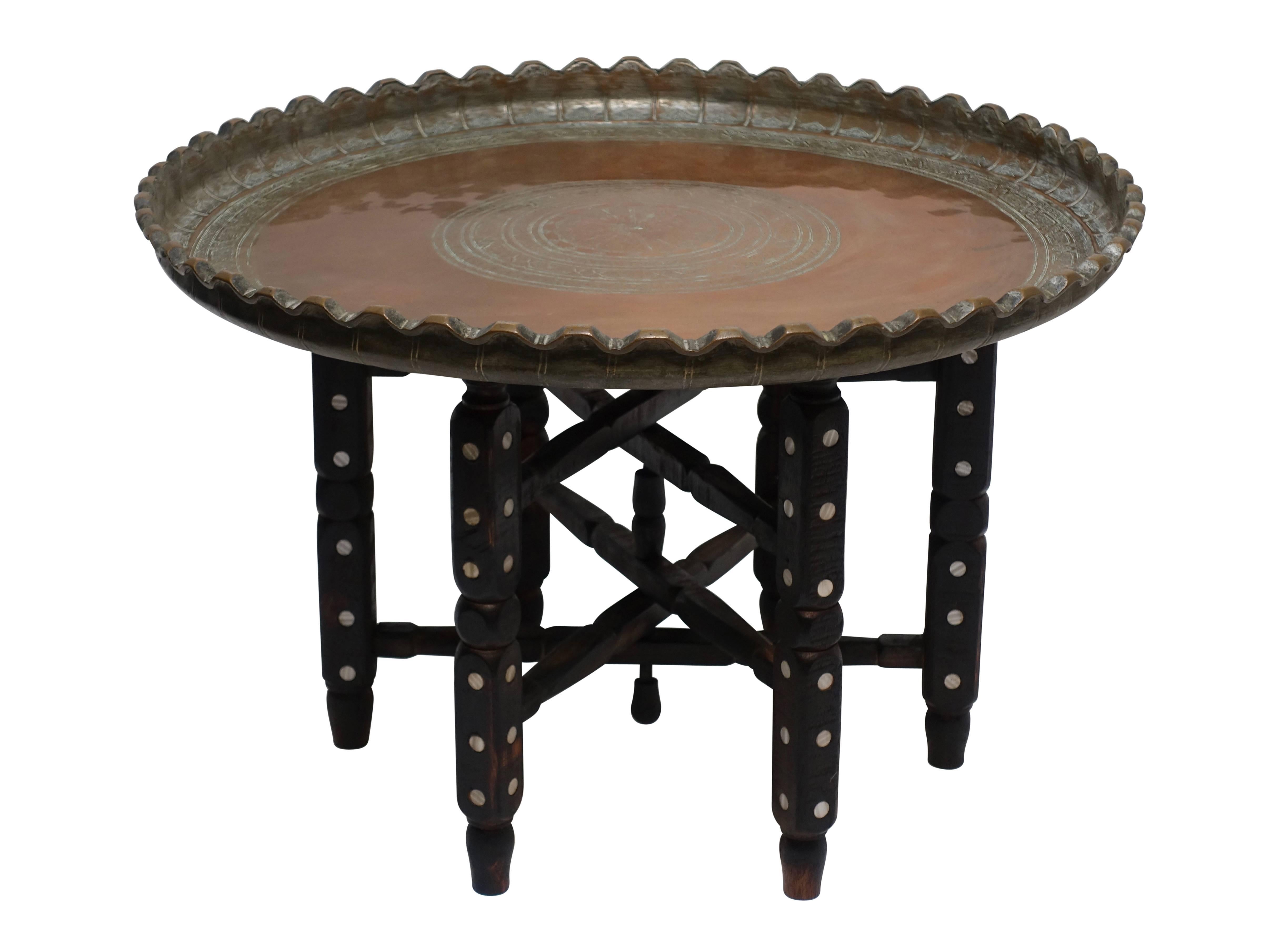 A Persian large copper tray on a handmade Turkish stand with mother of pearl inlay. The 19th century handmade tray is of beautiful quality with a solid heavy weight.