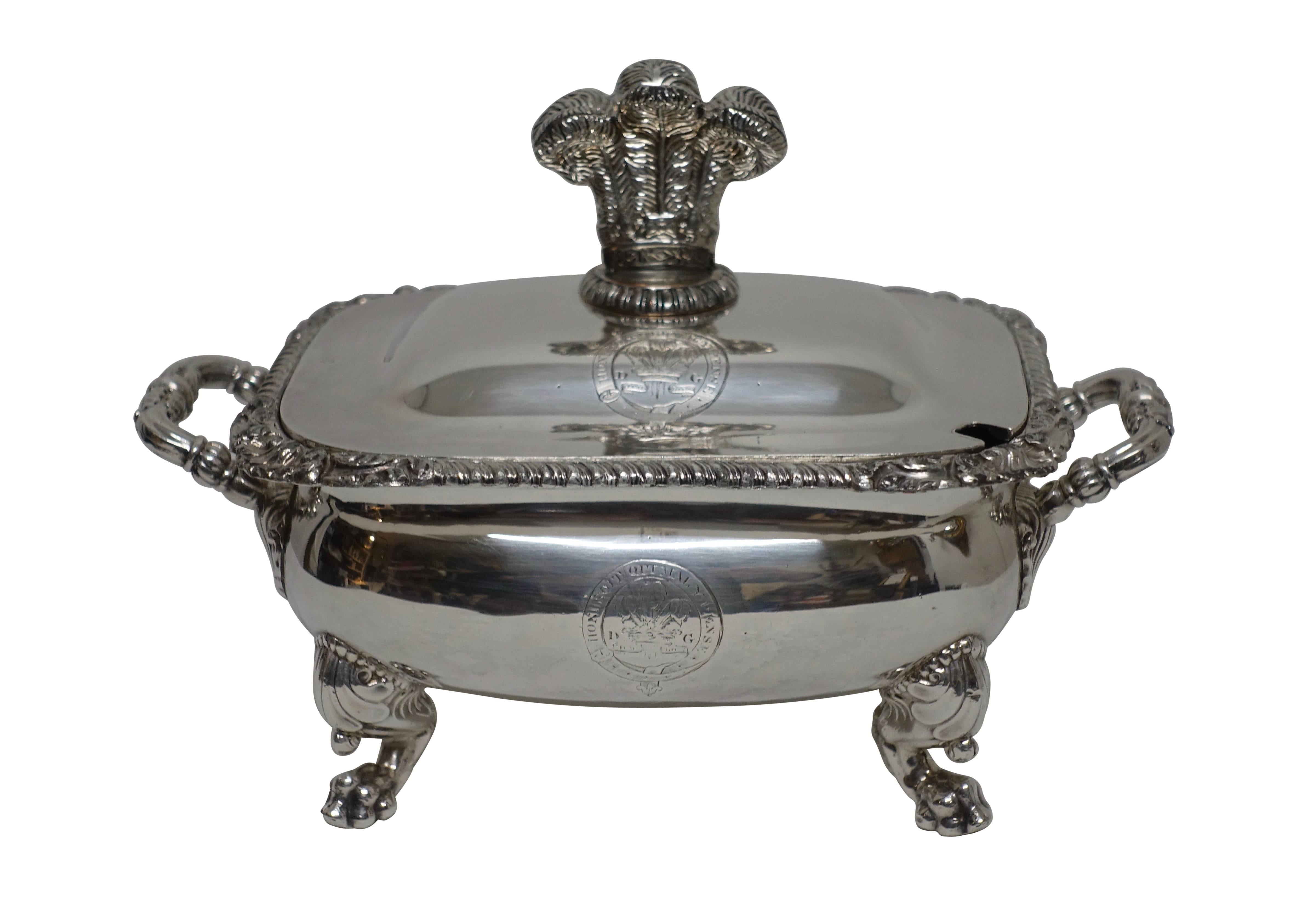 Stunning pair of sauce tureens with Prince of Wale Plums on the lids. Both the tops and body are engraved with the Motto. Gadrooned border with clam shell corners standing on winged lion paw feet. Hallmarked, English, late 19th century.