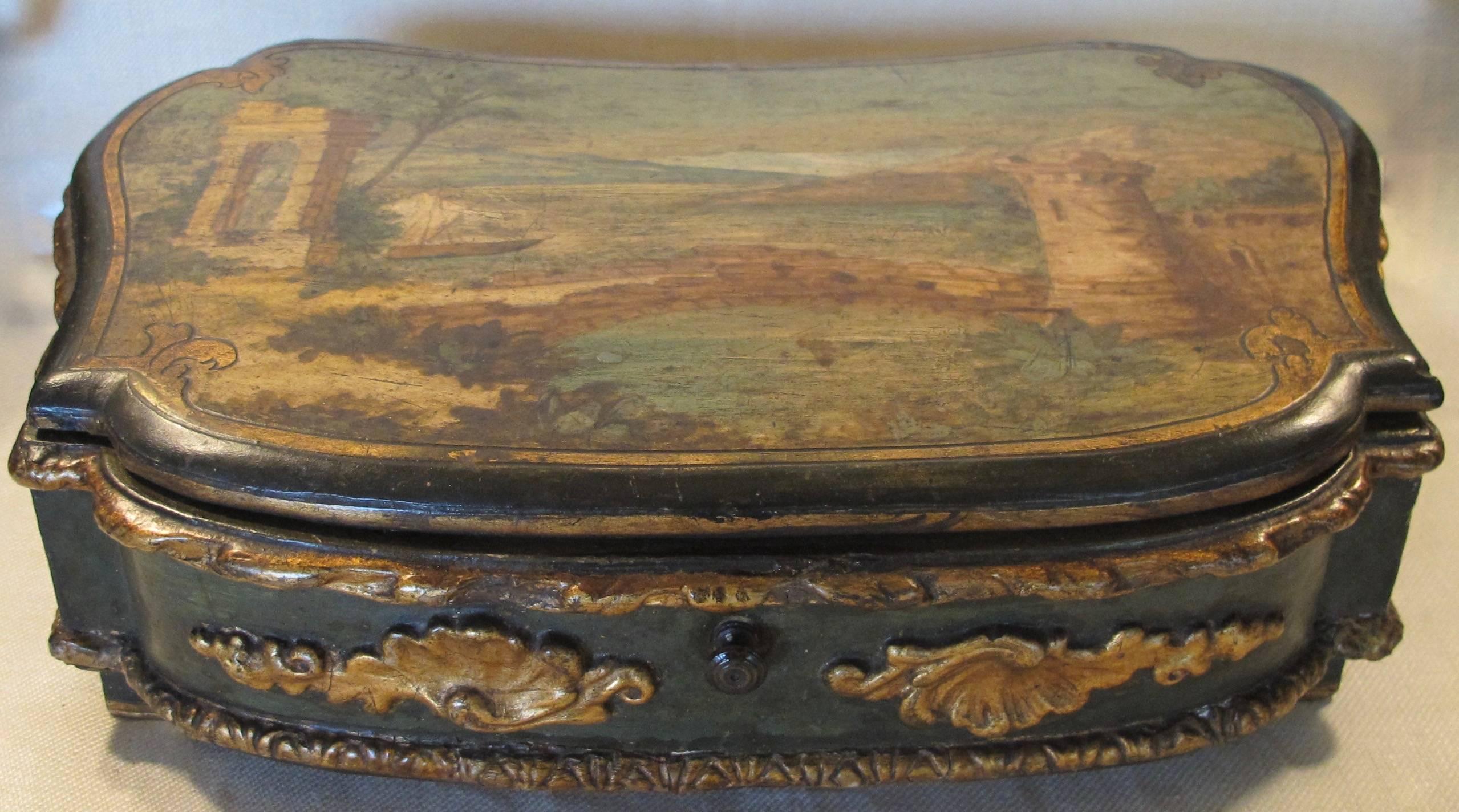 Wonderful kidney shaped box, hand-painted on the exterior top and decoupage and hand painted inside the lift up top, four separated compartments decoupaged. With gilt shell and twisted cord moulding around the edges. English or Continental late