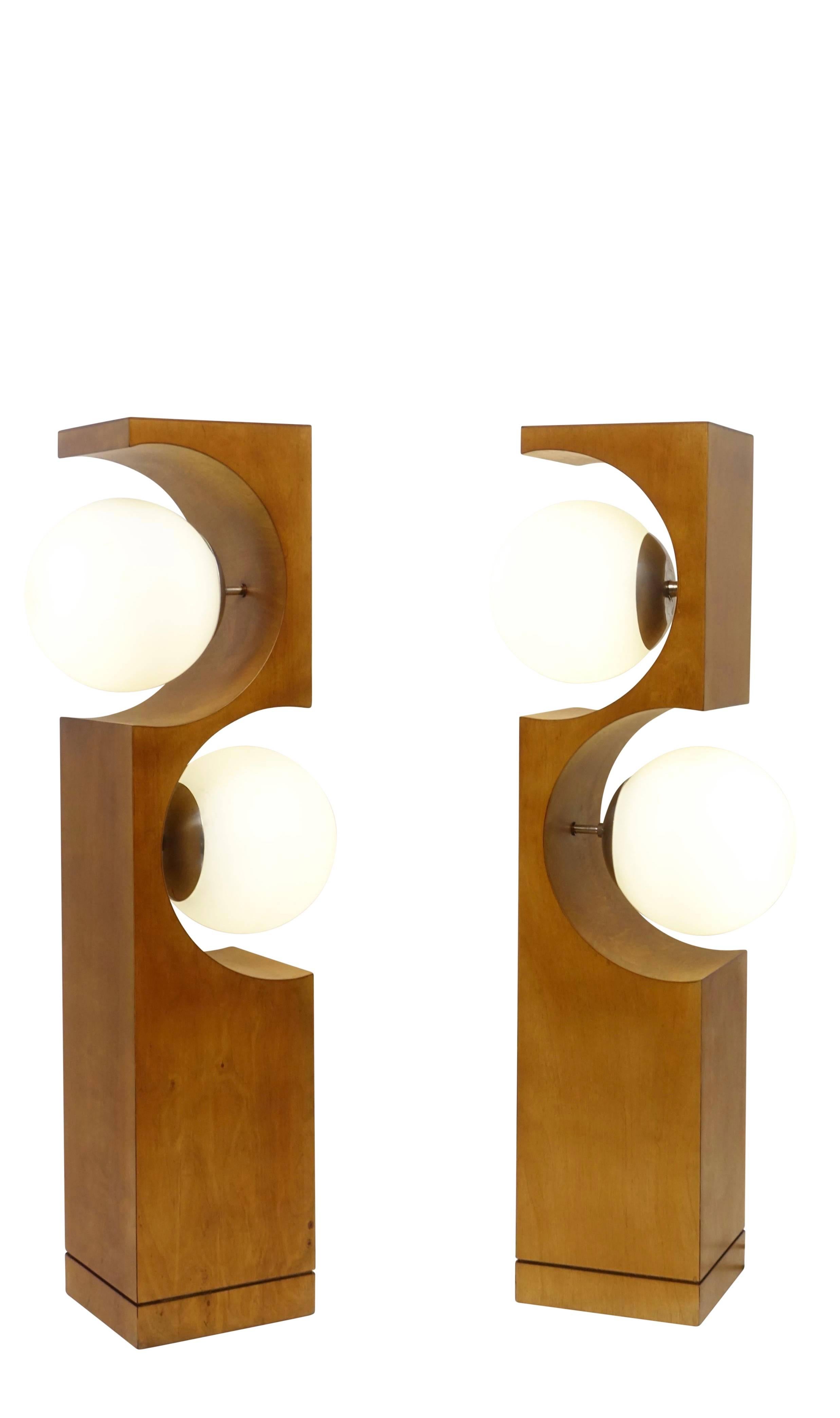 A pair of large midcentury Milo Baughman wood table lamps, having two glass orb shades. Recently reconditioned and re-wired.