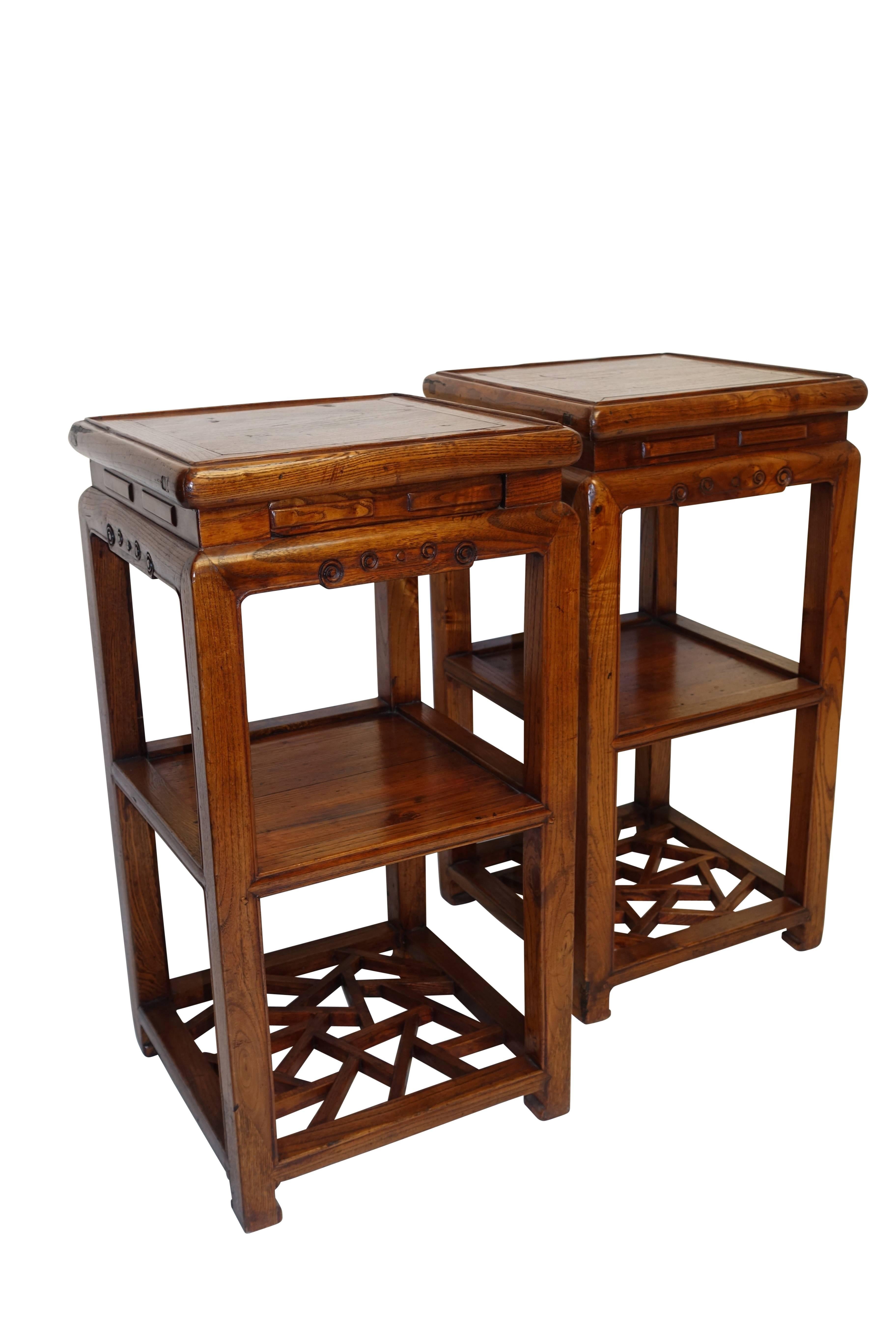 Wonderful pair of elmwood two tier stands or pedestals with secret drawer in the apron. Each stand having a lower shelf and a lower stretcher in broken ice design, standing with feet ending in chow foot. China, Qing dynasty.