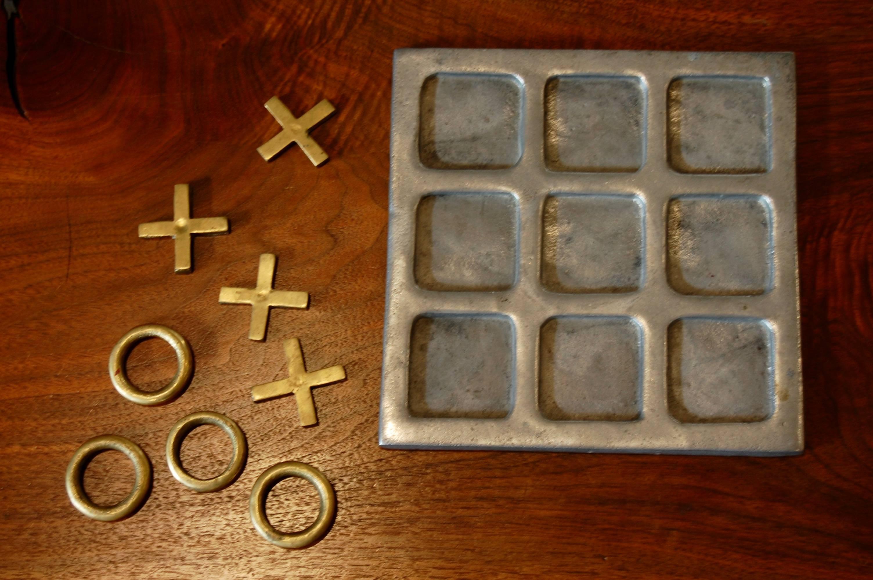 1970s Tic Tac Toe game with a cast aluminum base with bass X's and O's.