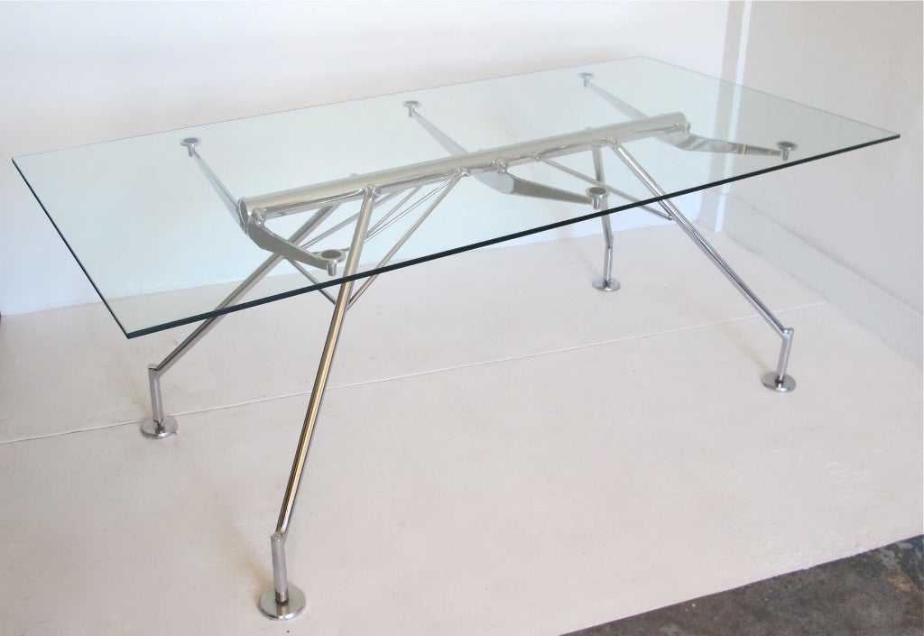 An Argentine licensed copy of the original iconic Norman Foster Nomos table. Chrome plated steel frame supporting a thick glass top. Works as a desk or dining table. 
Will set eight comfortably.
Very good construction and quality.
Glass shows some