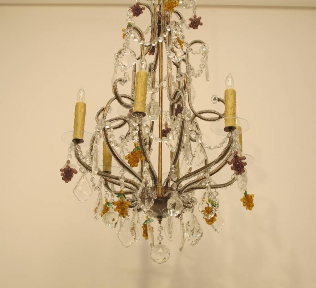 Vintage Italian six arm beaded glass chandelier with amber and amethyst color grape clusters, crystal pendants and glass bobeches. Newly re-wired, holds chandelier size bulbs.
Italy, Mid-20th Century.