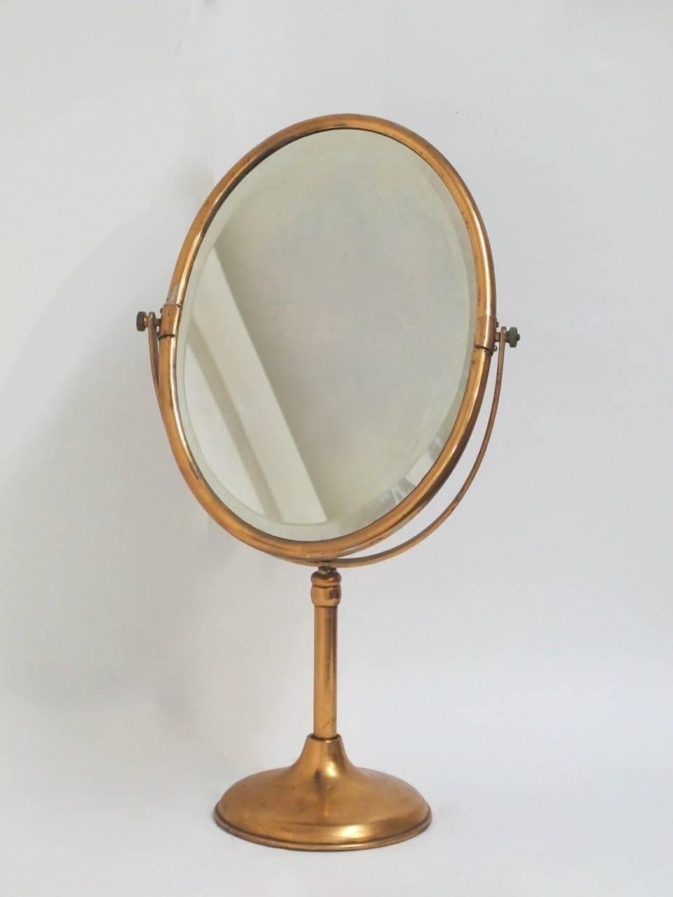 A large scale and unusual copper flashed over nickel silver store display mirror. In original condition and with original beveled glass mirror.