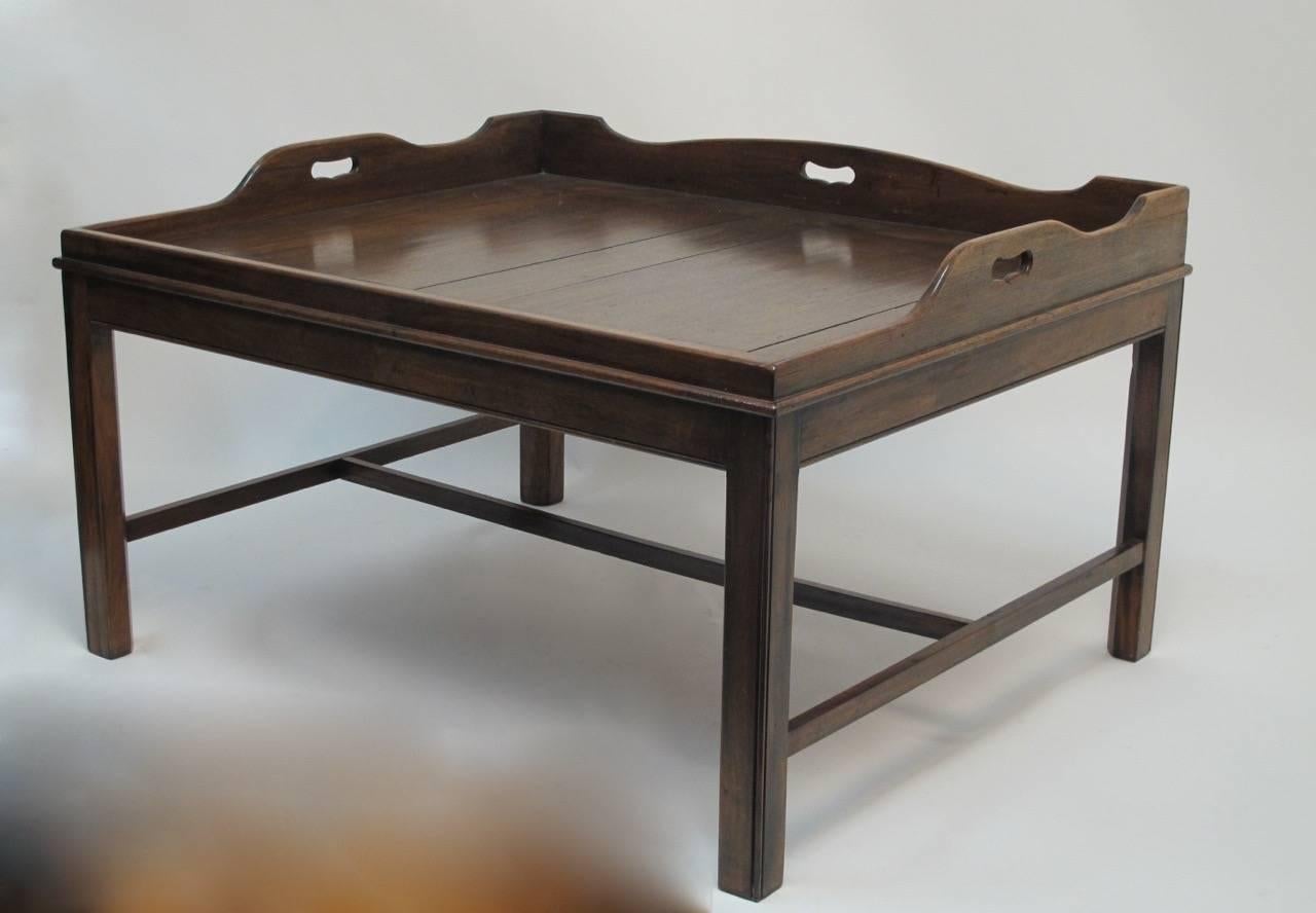 Large scale Georgian mahogany butlers tray on later Georgian style base. The tray lifts off the stand.