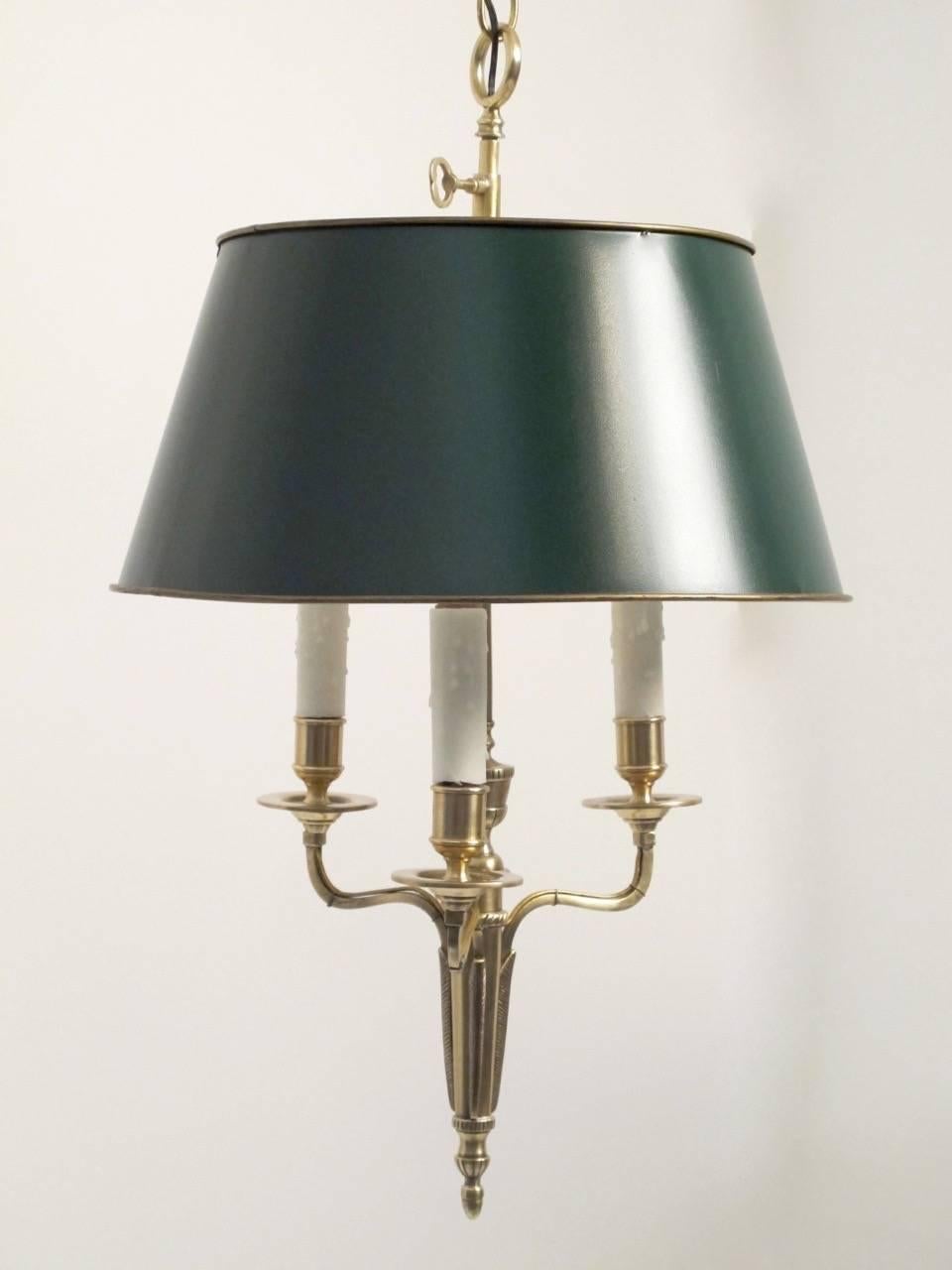Three-light hanging bouillotte brass candle lamp with wax candle sleeves and green painted tole' shade. Recently restored and converted to electric, French, late 19th century.