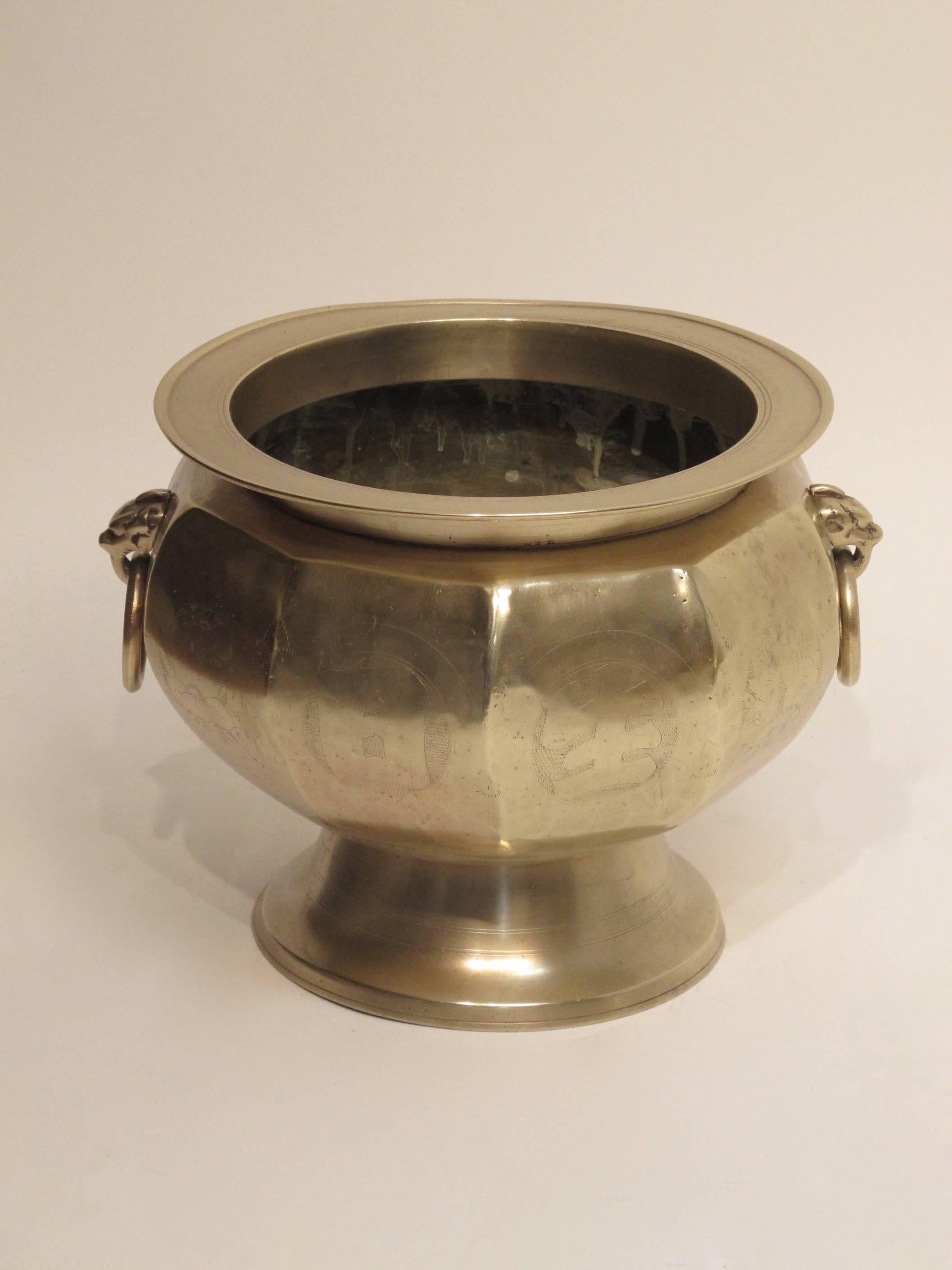A heavy bronze brazier or footed pot with etched design around the body and base. Recently polished, early to mid-19th century.