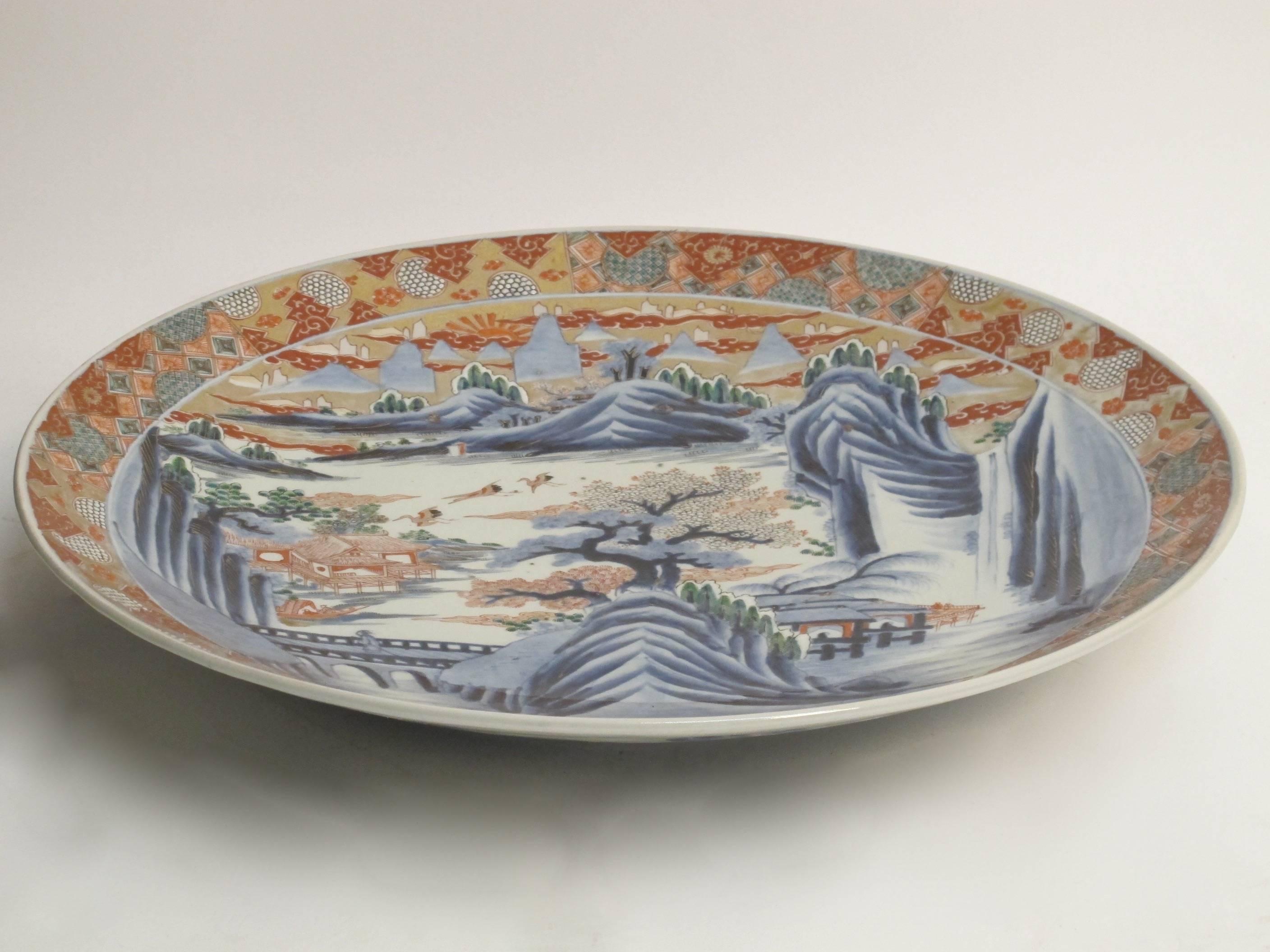 A beautiful and large late 19th century Meiji period hand-painted Imari charger. The charger has one small flaw in the glaze (this is not damage but happened during the firing process, please see the last photo for close-up).