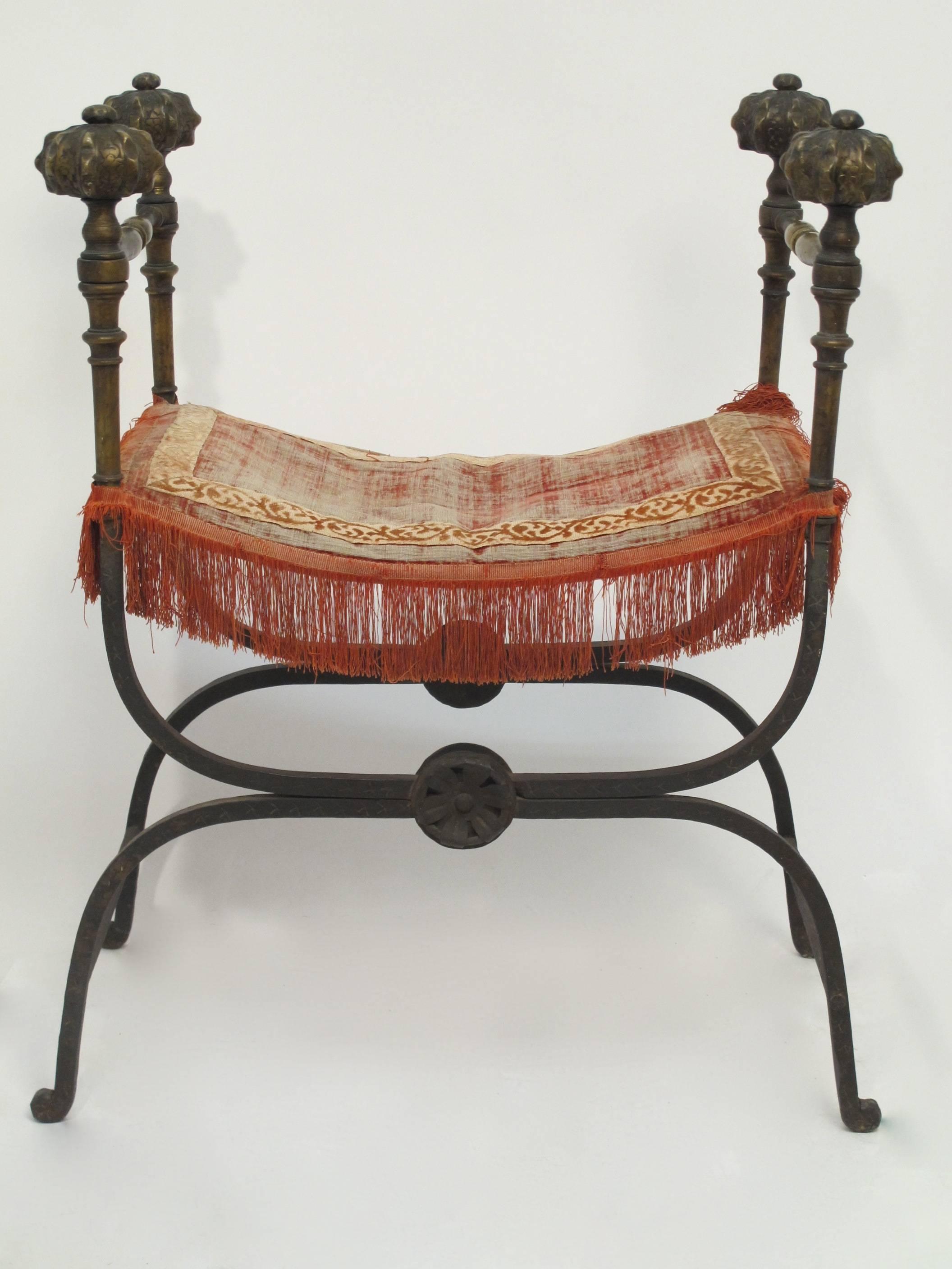 A 19th century savonarola style chair or bench, all hand wrought iron with four ornate bronze finials. Original unrestored condition.