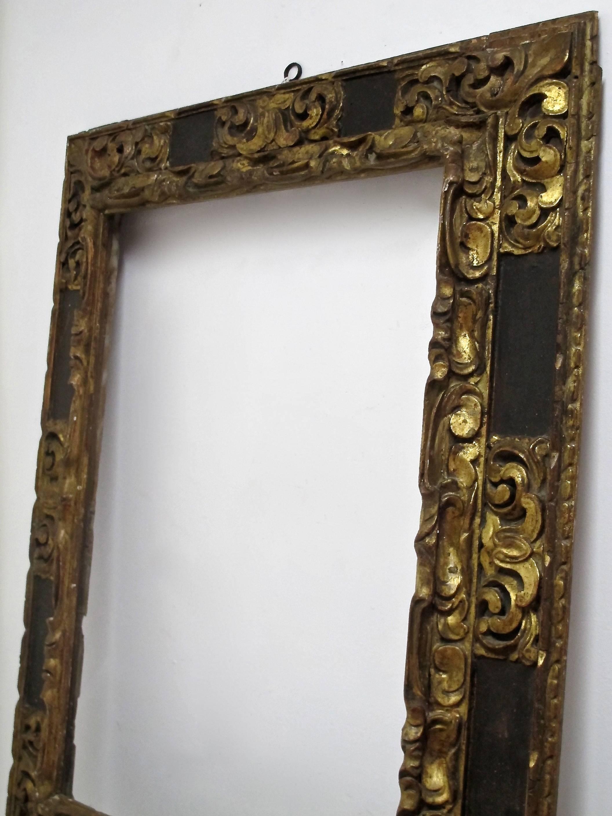 A truly extraordinary large carved, painted and gilded Spanish Colonial painting frame in original condition. The inside measurements on the frame are 33.5 X 25. Spain, 18th century.