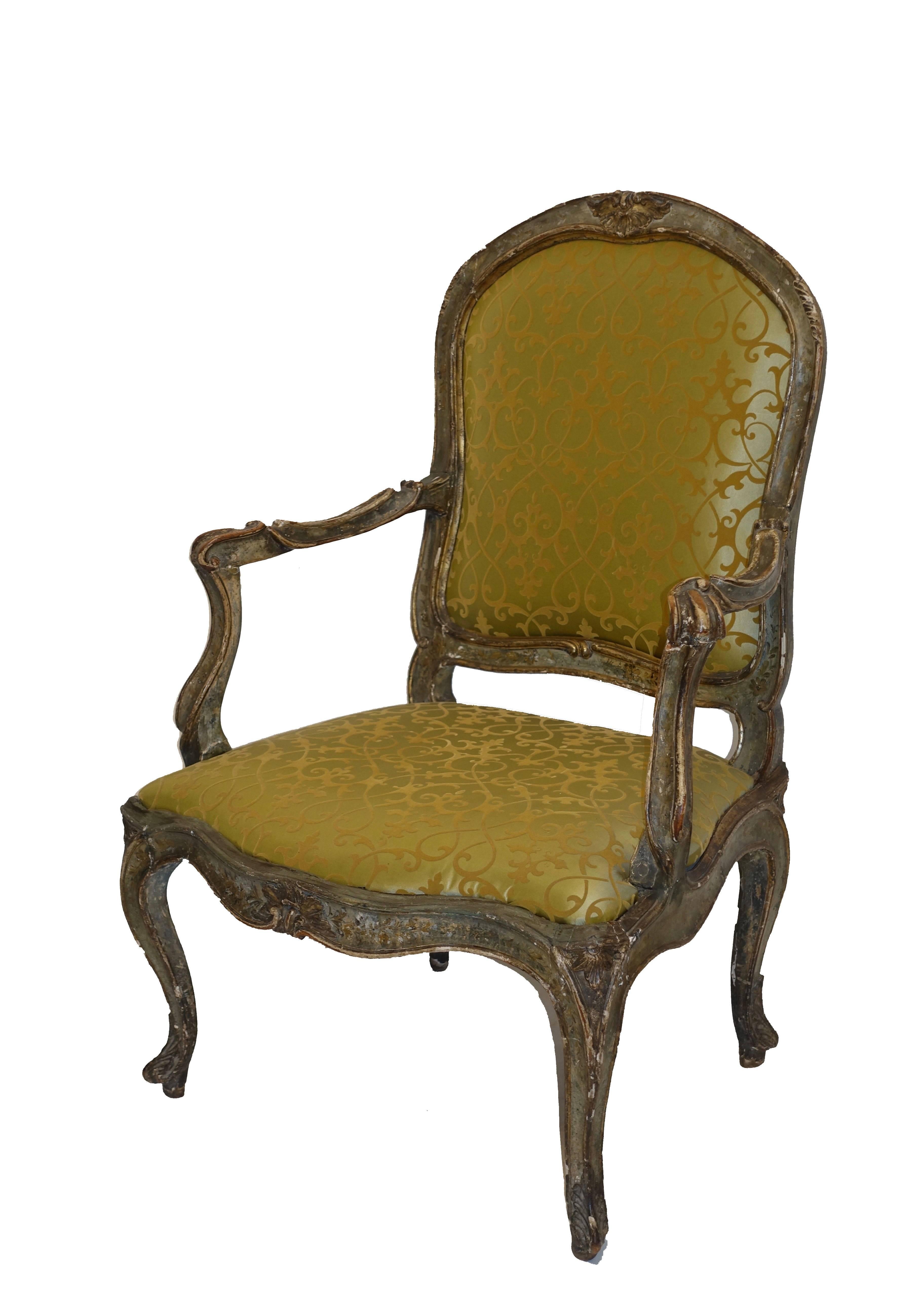 Beautifully carved wood and hand-painted armchair, retaining most of its original painted finish. This chair is a good size with a generous seat. Recently reupholstered in a silk fabric. Italy, 18th century.