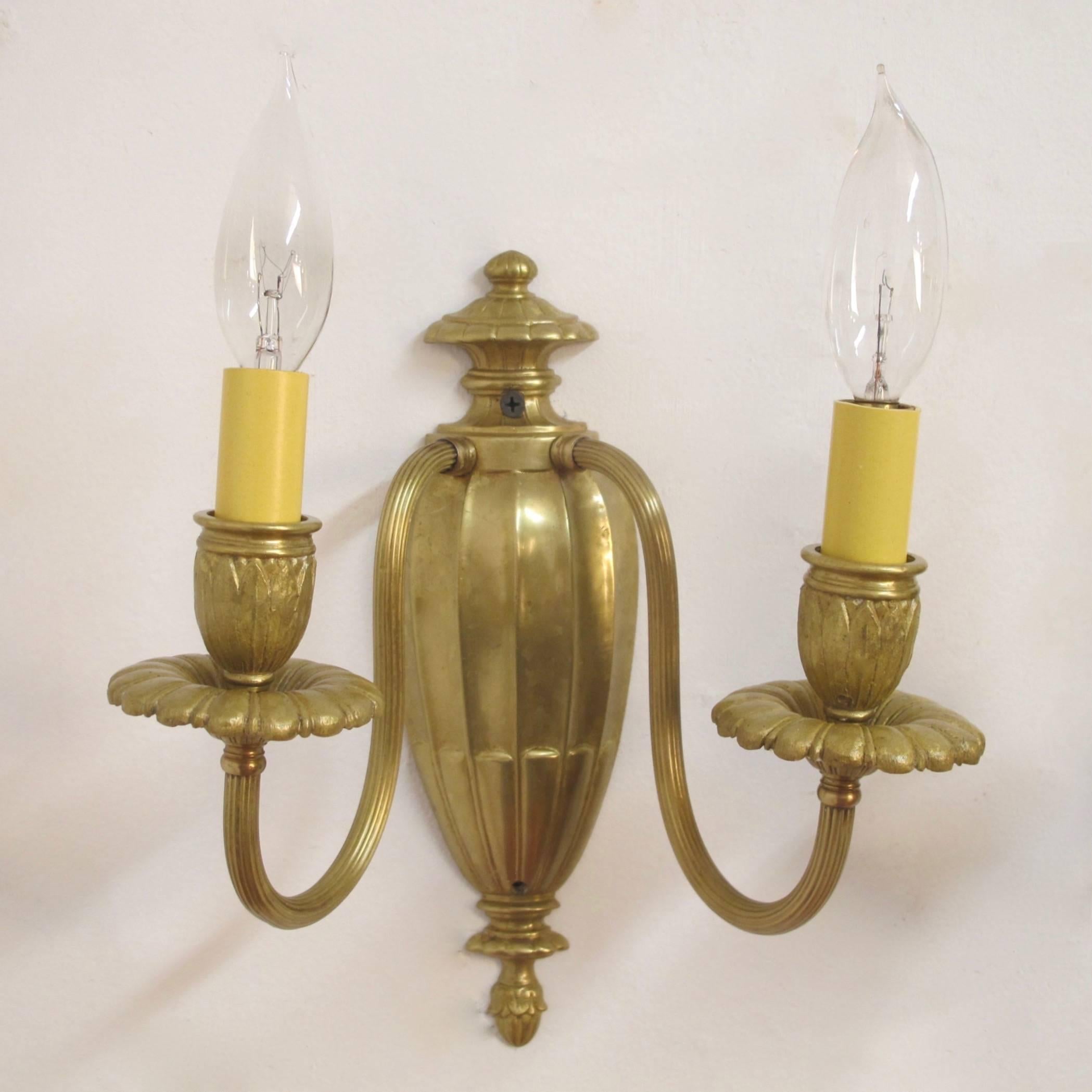 A pair of brass wall sconces is the Georgian manner. Recently re-wired with candelabra size bulb sockets, England, circa 1920.