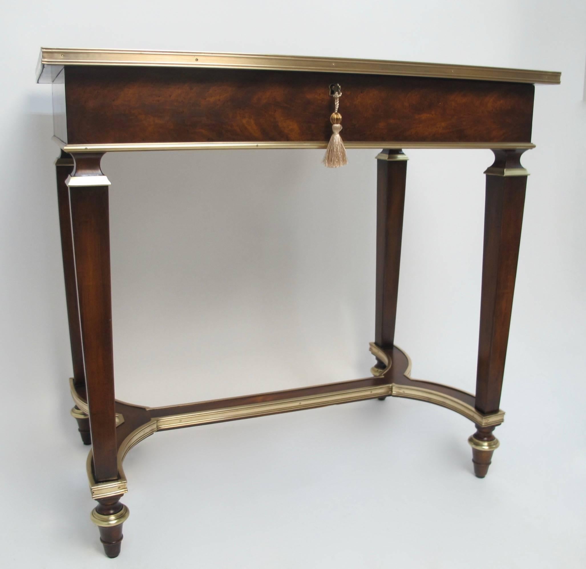 A fine quality mahogany with bronze trim vitrine.  Beveled Glass top opens to a velvet lined interior, and working key. England, Early 20th century.