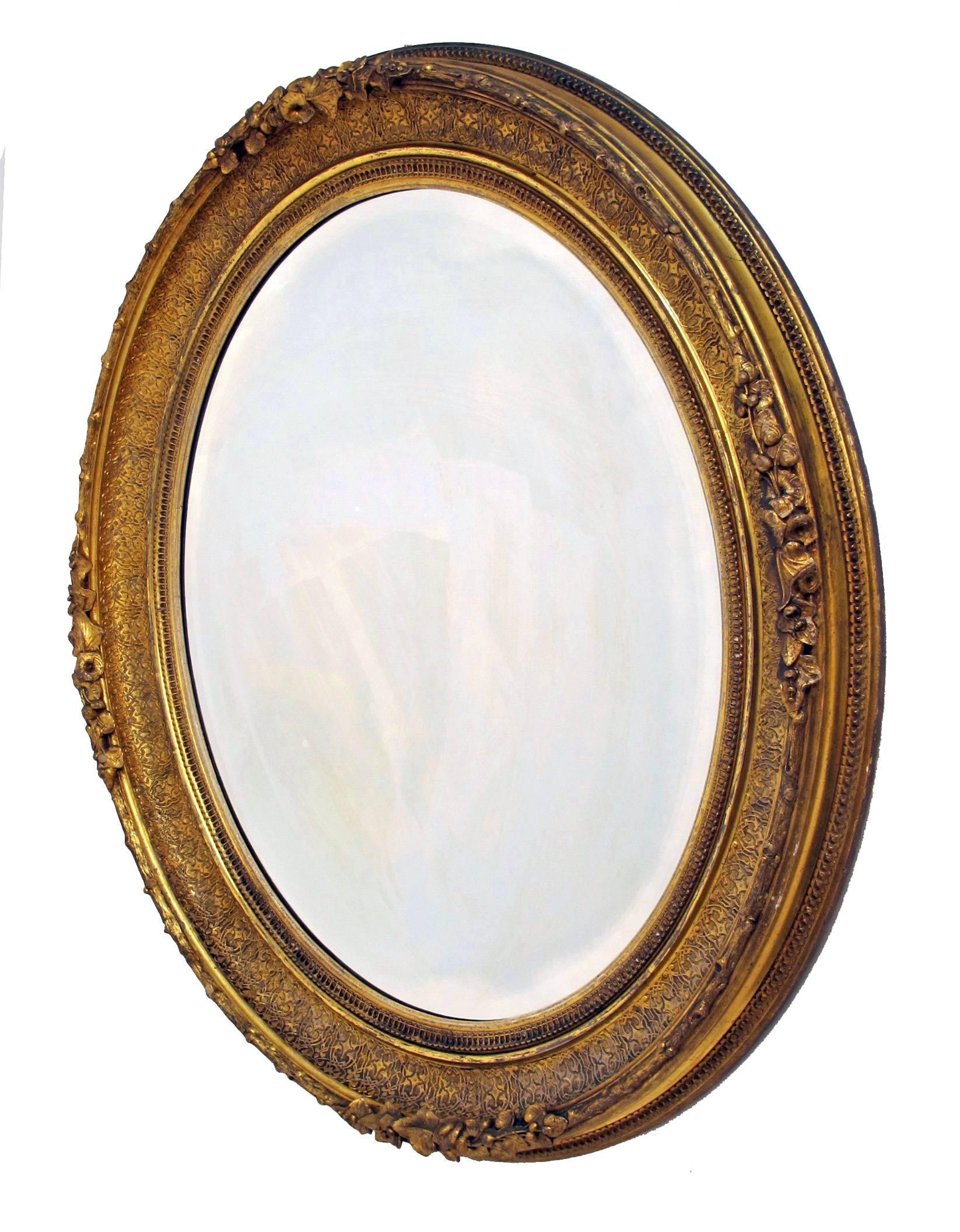 Large oval shape gilt and beveled glass mirror in beautiful original condition, American, 19th century.