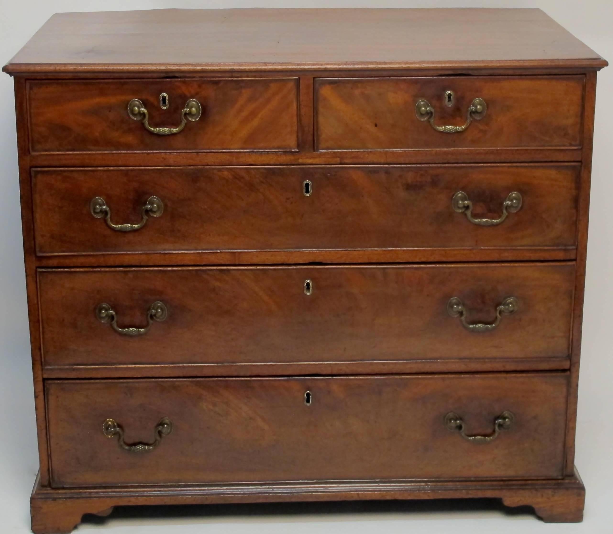 George III mahogany chest of drawers with two short drawers over three graduated drawers having figured mahogany drawer fronts. Sitting on bracket feet and having original drawer pulls, English, circa 1820.
There have been restorations and