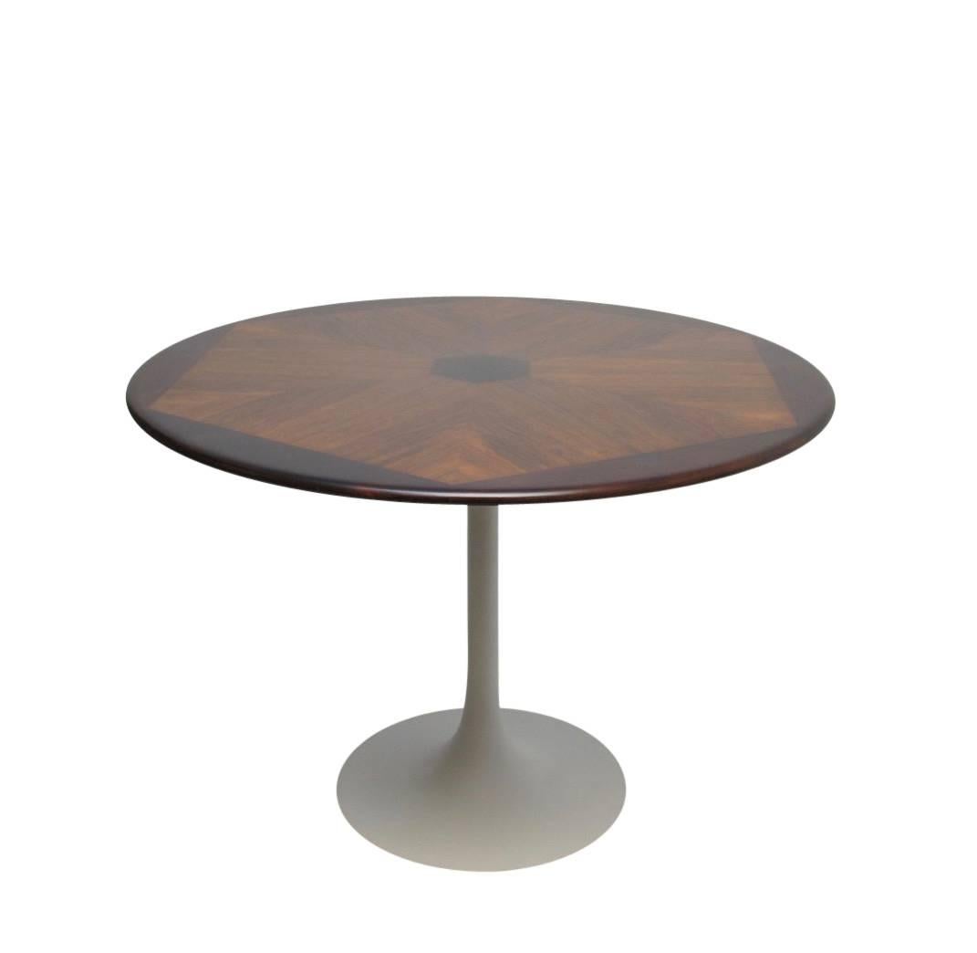 Rosewood dining table with inset rosewood design supported on a white painted metal Saarinen style base. American, mid-20th century.