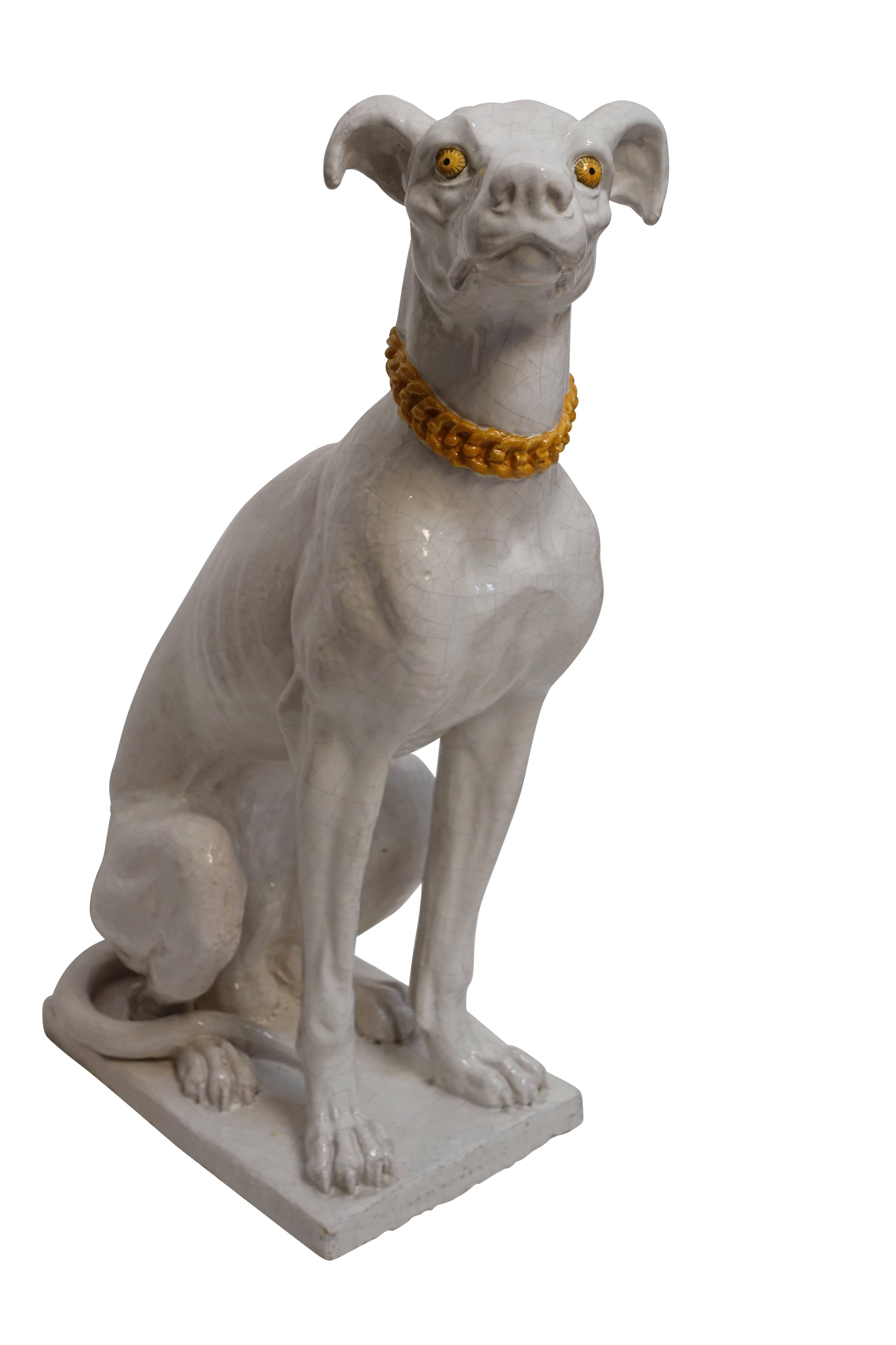 Large faience pottery greyhound or whippet dog statue, white glaze with yellow accents. Italy, 1950s-1960s.