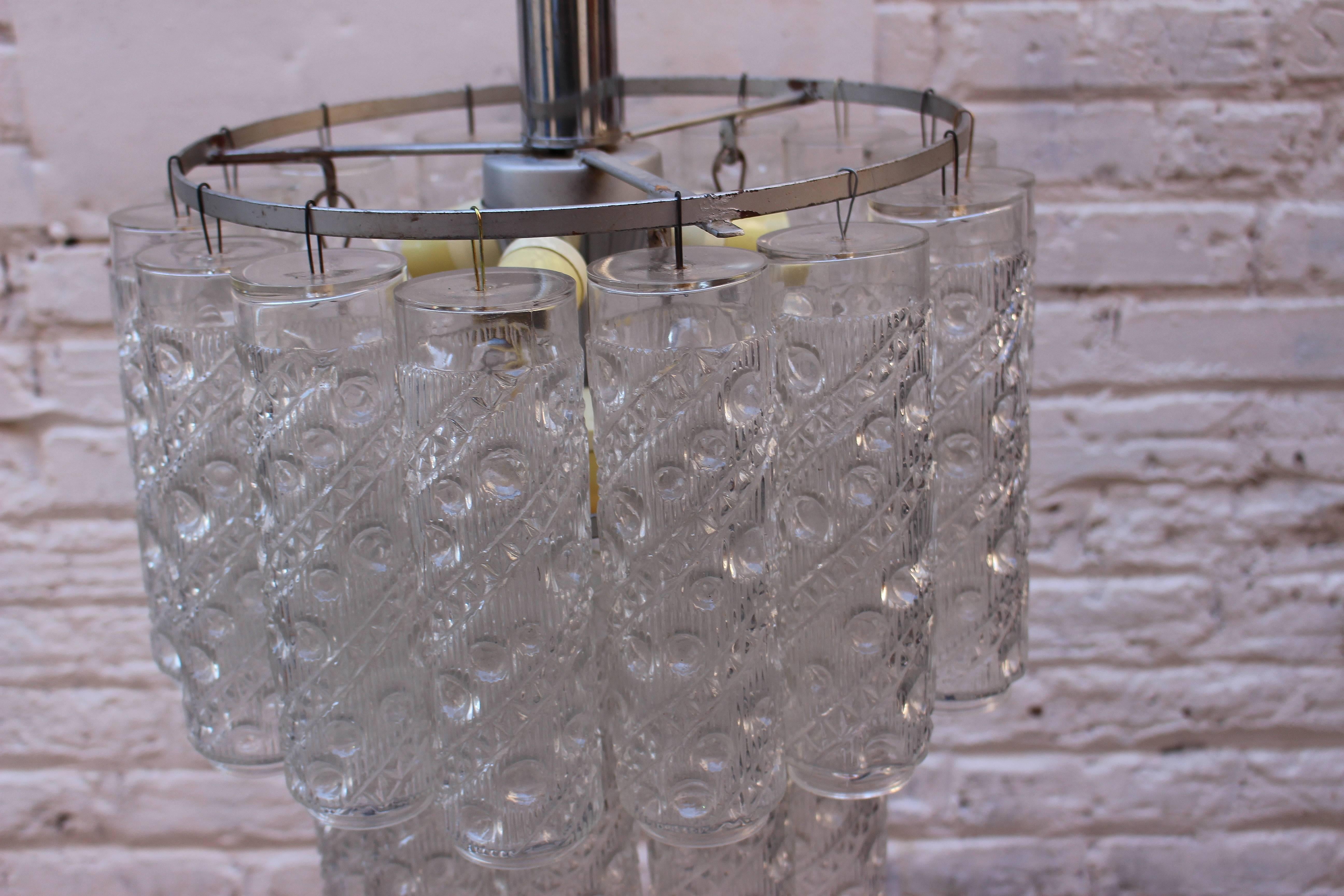 Tubular glass chandelier. 
Fixtures net is 22 inches without the chain.