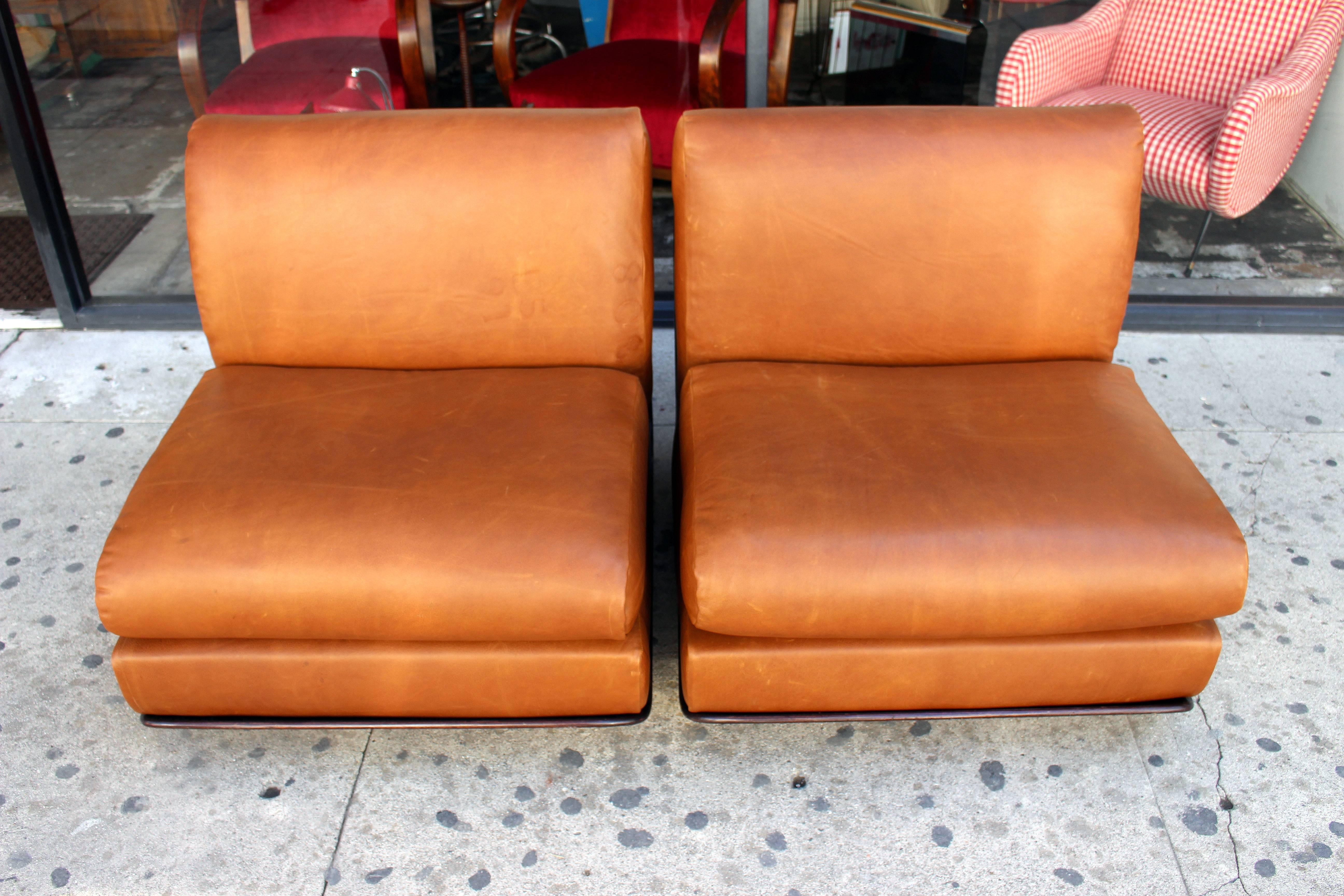 Mario Bellini palisander wood and leather lounge chairs.