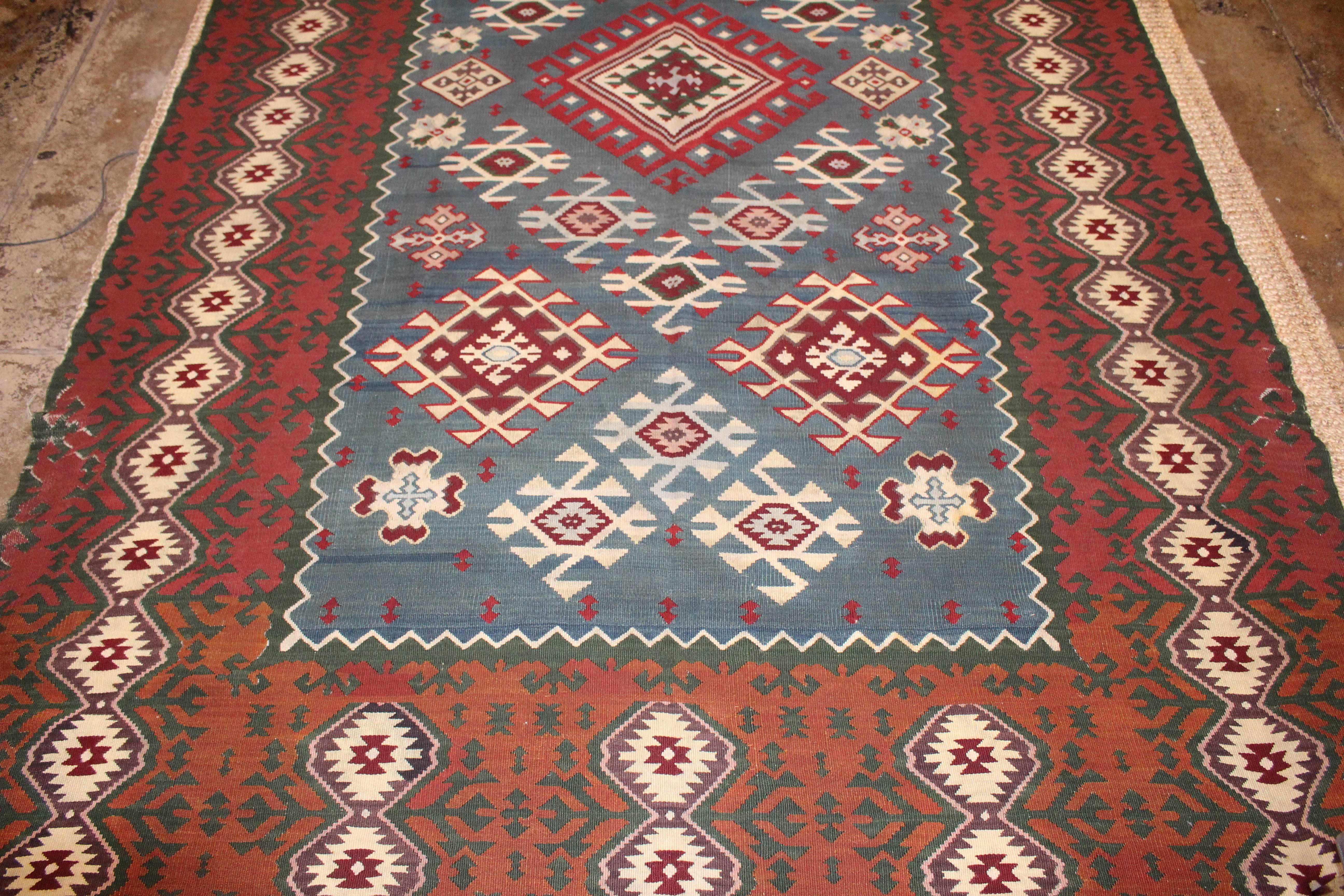  Turkish Killim from Balkan in original condition.Indigo center base and Earth tons combine in to the beautiful large Kilim 
