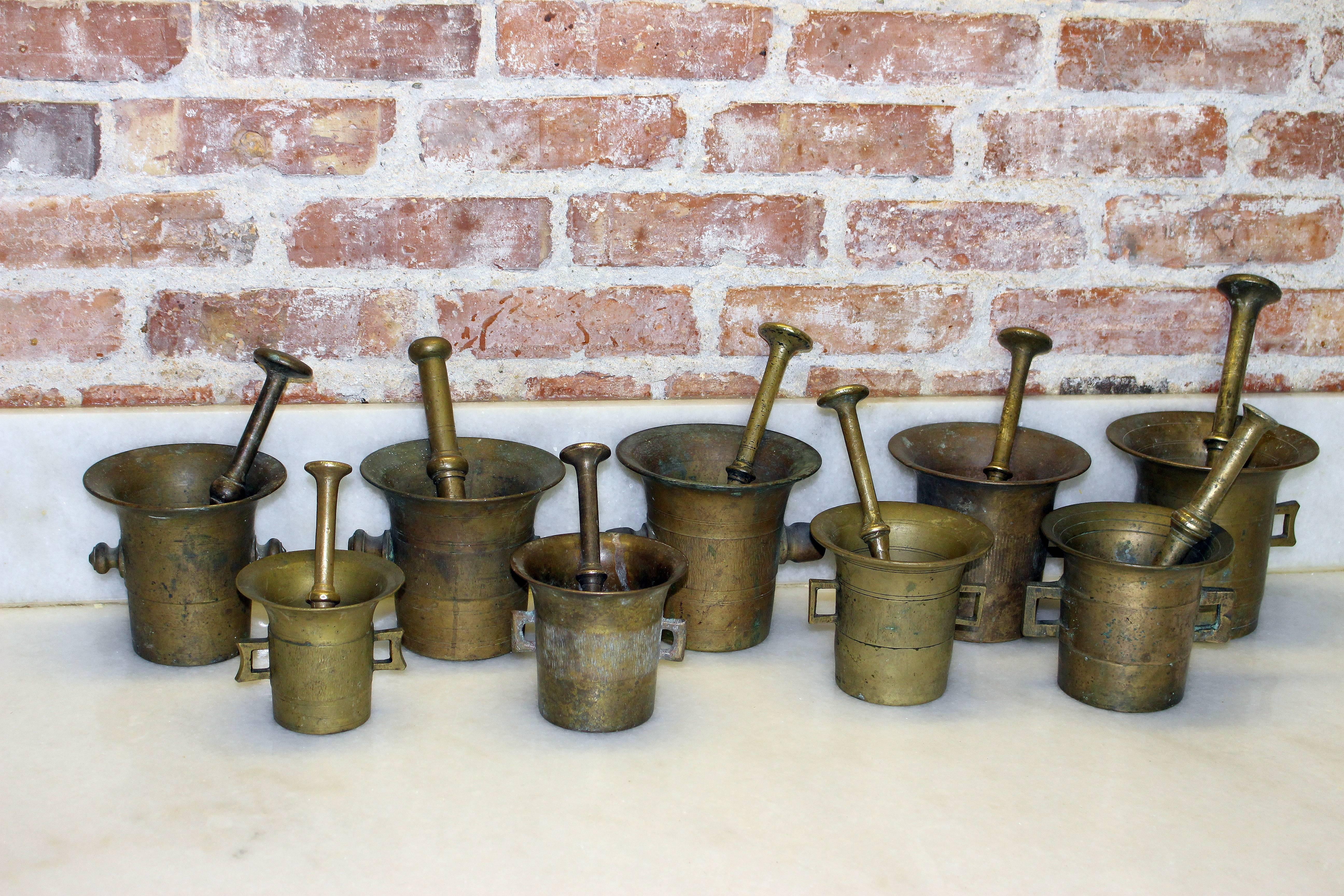 Apothecary heavy European brass and bronze mortars and pestle perfect for the kitchen. Original condition wonderful patina. The big piece H 6 with the pestle 11 inches diameter 6.5 inches. Small H 4 with pestle 6.3 inches,
 diameter 4.5 inches.