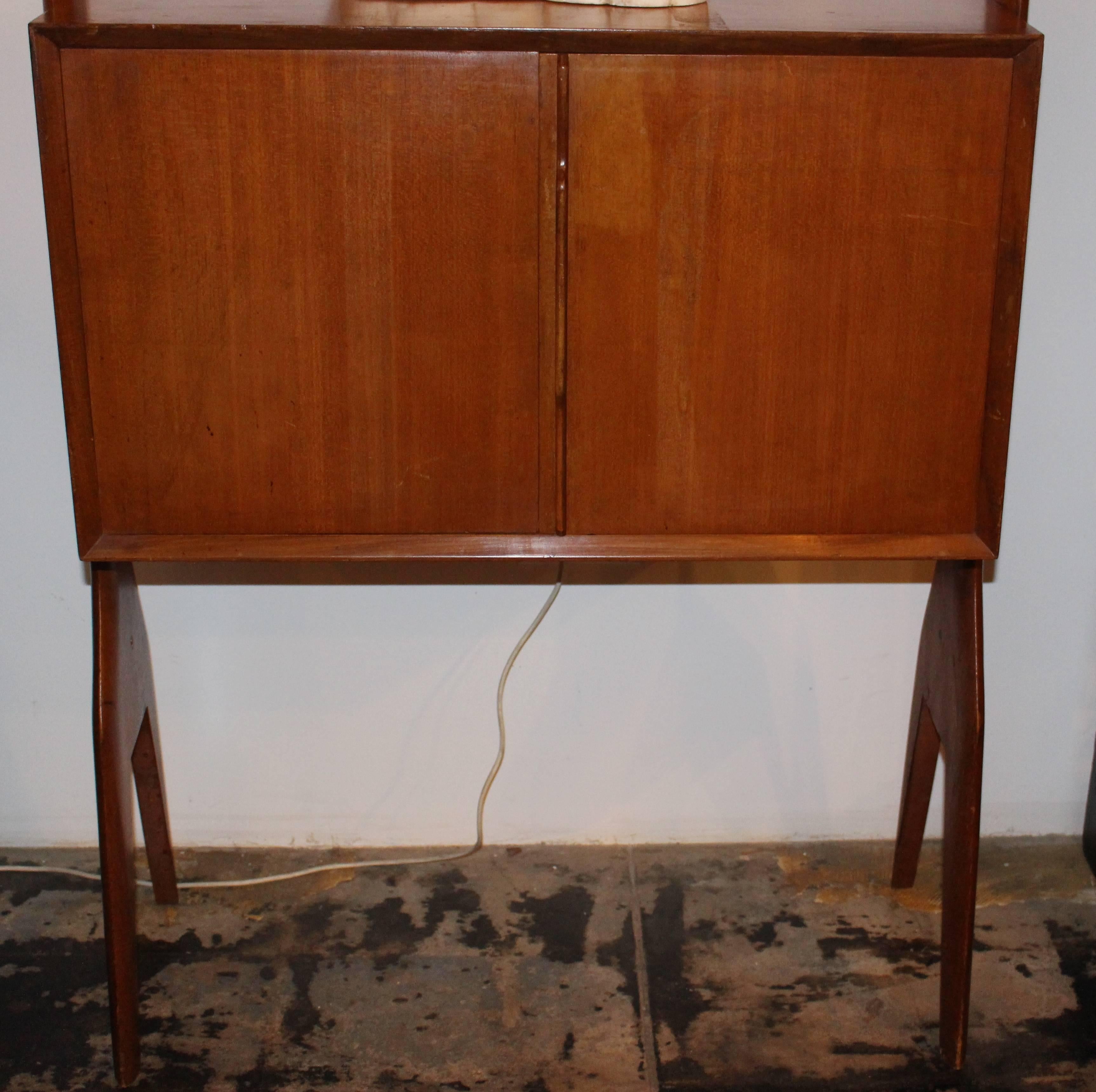 Mid-Century Italian bock shelf. Storage compartment has a glass shelf inside.
Bock shelf has adjustable height shelving.