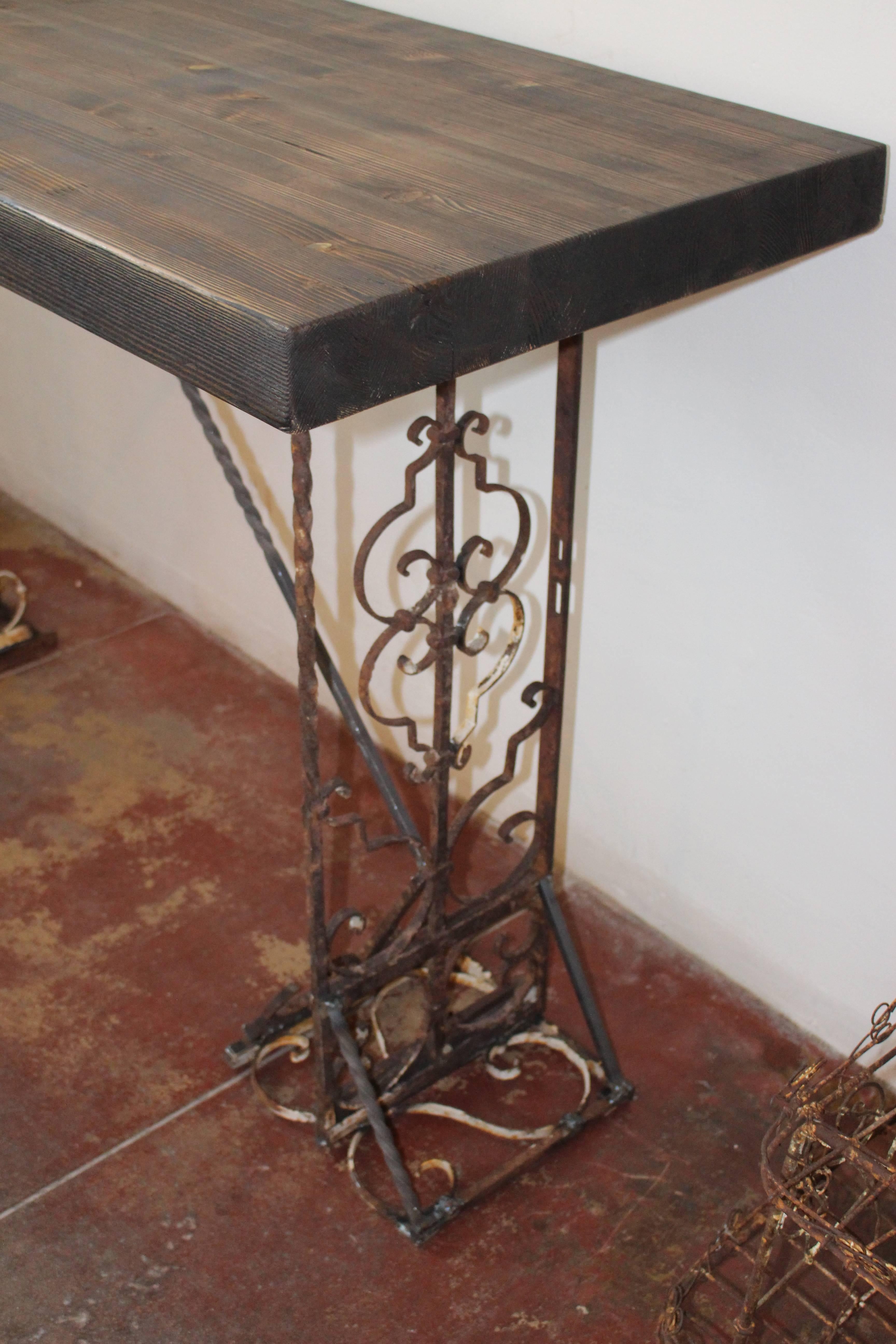 Bar table buy Studio ACA in North Italy 3 inch tick wood top, 19th century base wrought iron 
ebony stain  reclaimed wood.
 