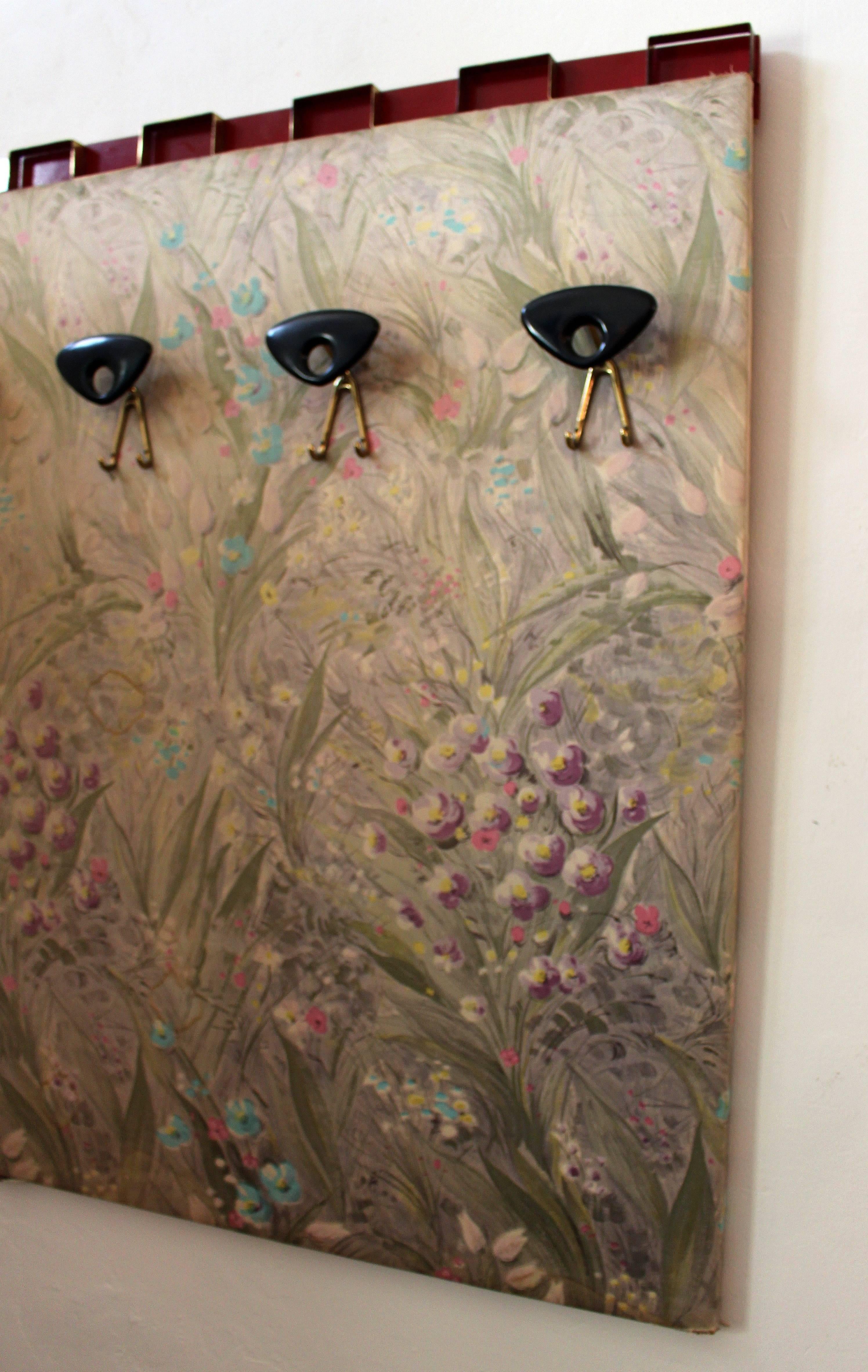 1950s, Italian wall coat rack from the Excelsior hotel in Trieste.
Brass hardware, hand-painted flower on the silk fabric.