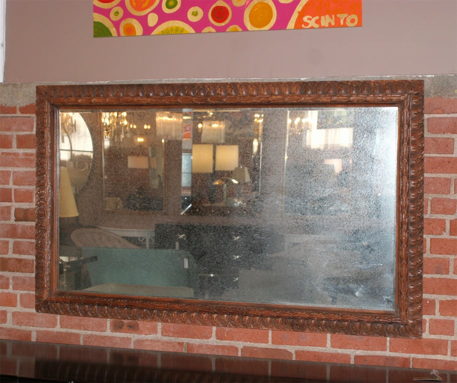 Carved rectangular mahogany distressed mirror. Mirror is in good vintage condition. Age unknown.