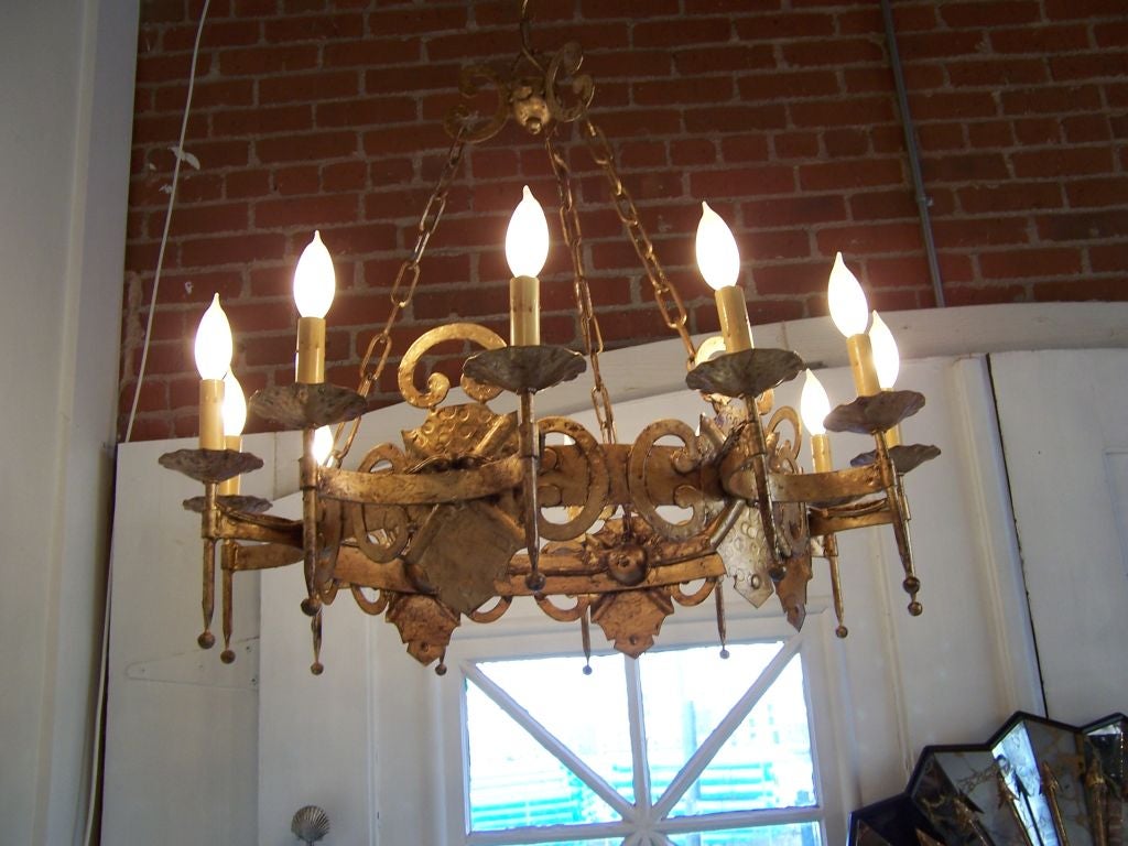 Large iron gold leaf chandelier with 12 lights. Rewired. Nice patina.