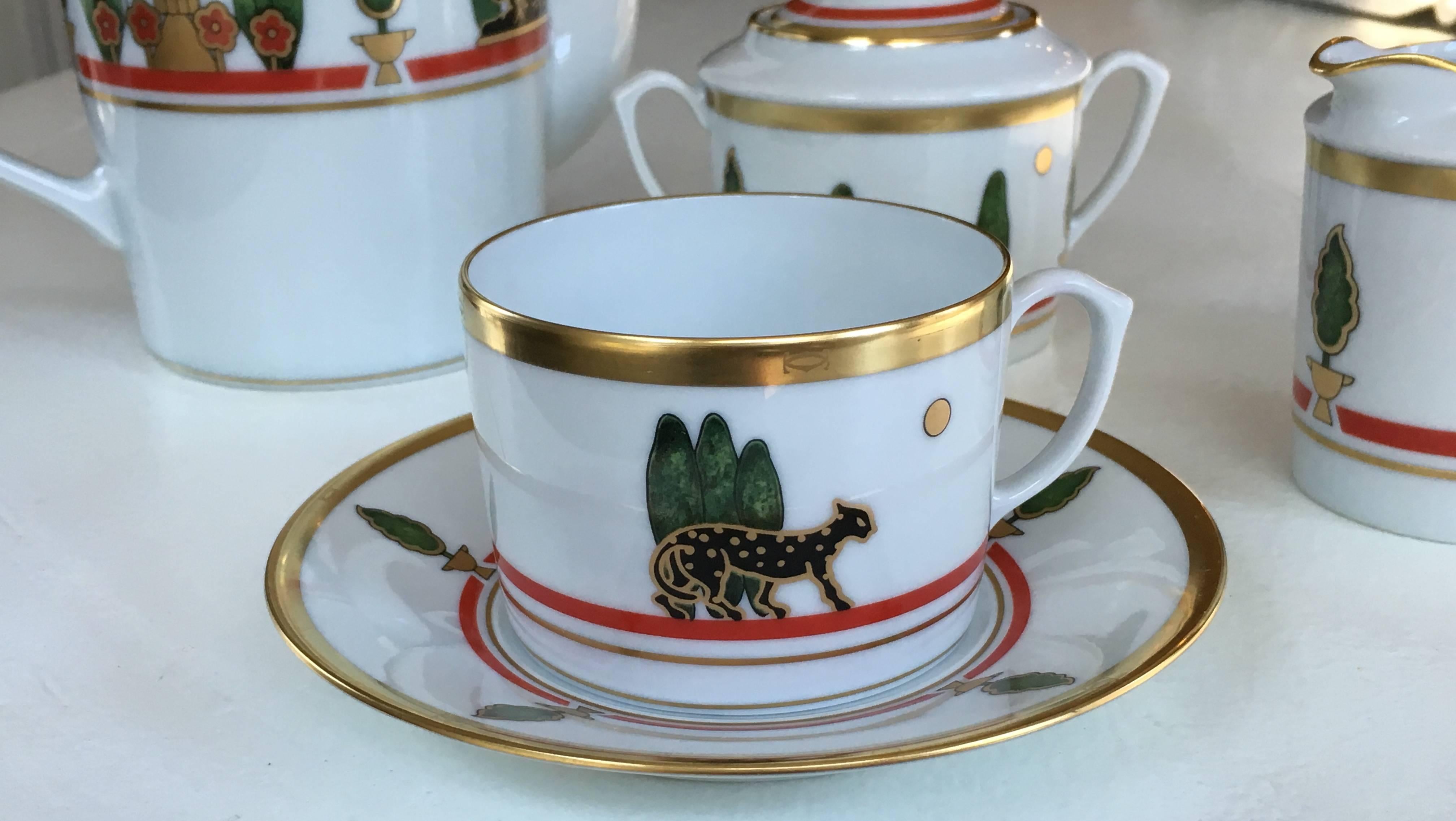 Featuring gold rim and detail, the classic Cartier black panther, red inner band and green bushes; in the 1980s Cartier and Limoges France collaborated on a line of fine porcelain. Price is for coffee pot and lid, sugar bowl and lid, creamer and 12