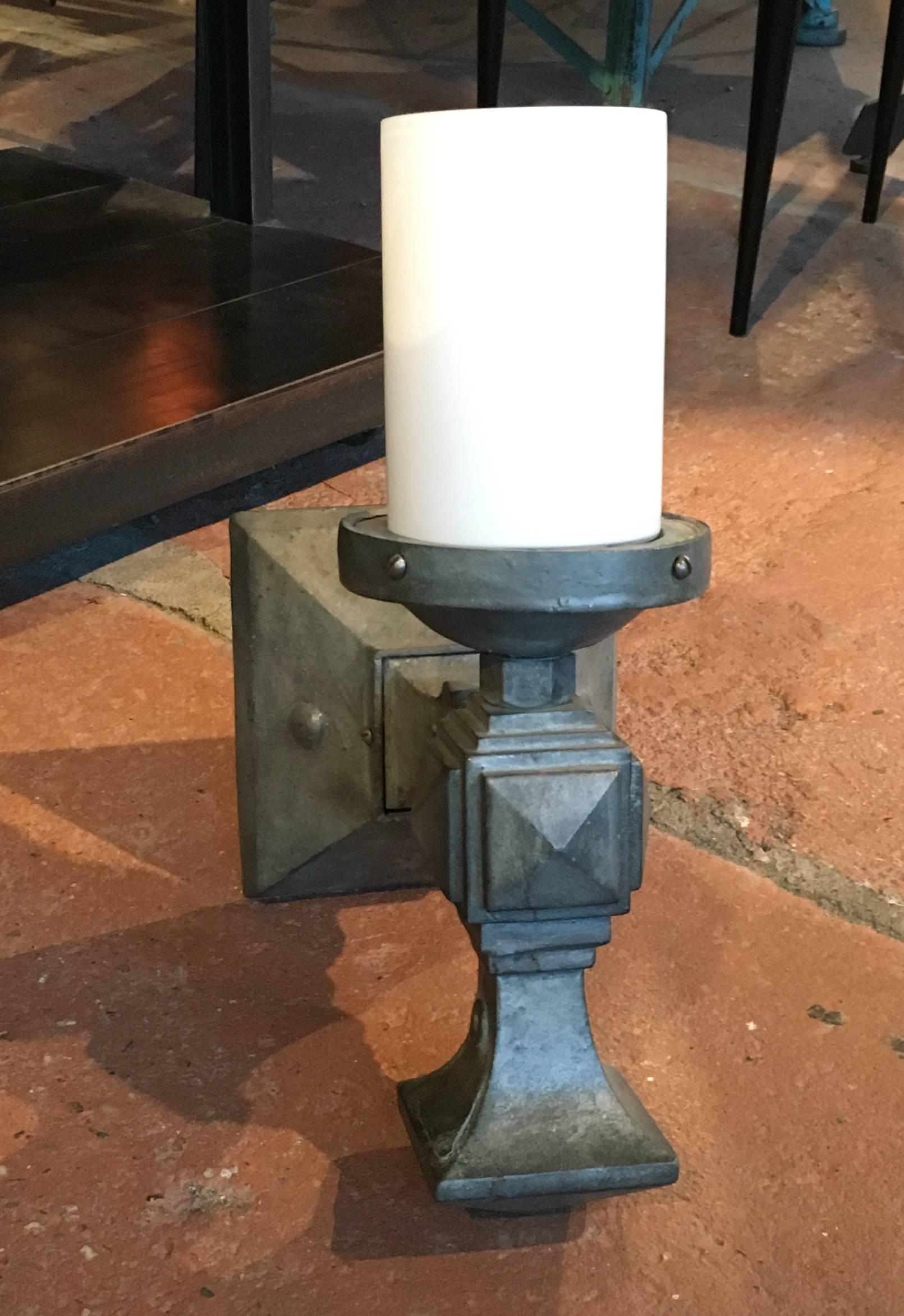 Pair of substantial French cast iron wall sconces, shown with white glass cylinder shade, but a variety of shades could be used.
Avantgarden Ltd. cultivates unexpected and exceptional lighting, furniture and design. To view items in person please