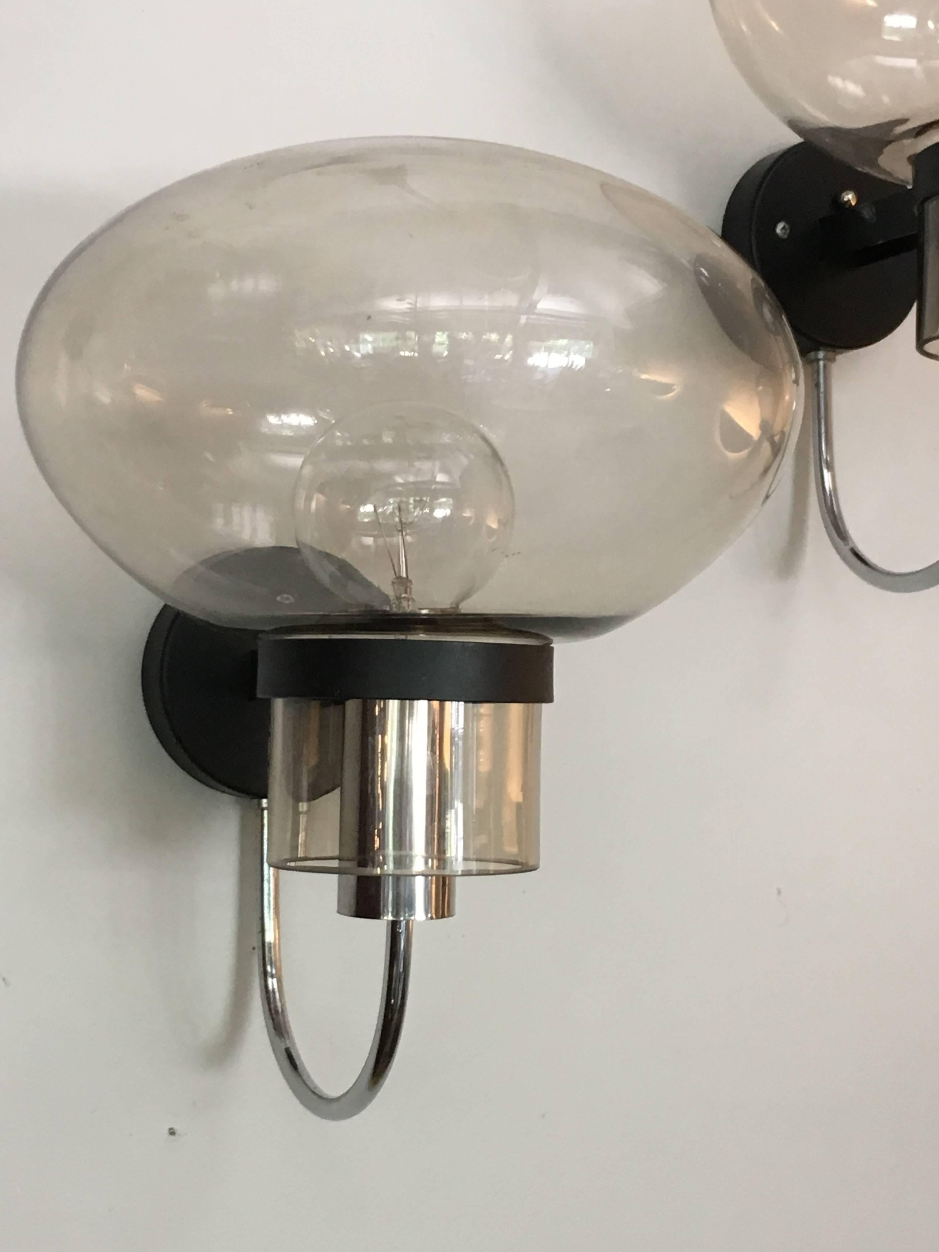 1960s Italian wall lights by Oluce with mushroom shaped glass globes.

Avantgarden Ltd. cultivates unexpected and exceptional lighting, furniture and design.  To view items in person please visit our showroom in Pound Ridge, New York. 