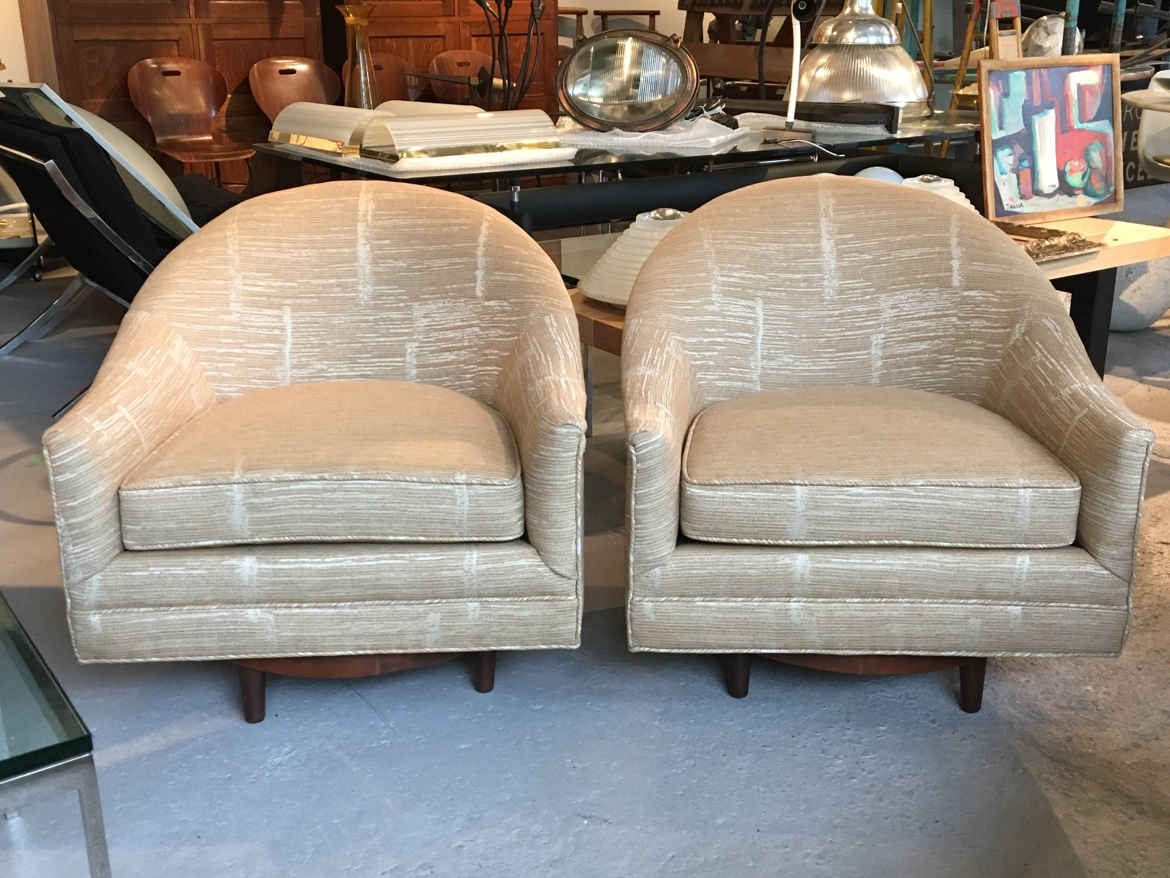 Pair of 1960s swivel lounge chairs by Selig, with walnut bases; all new upholstery, excellent sturdy construction.

Avantgarden Ltd. cultivates unexpected and exceptional lighting, furniture and design. To view items in person please visit our