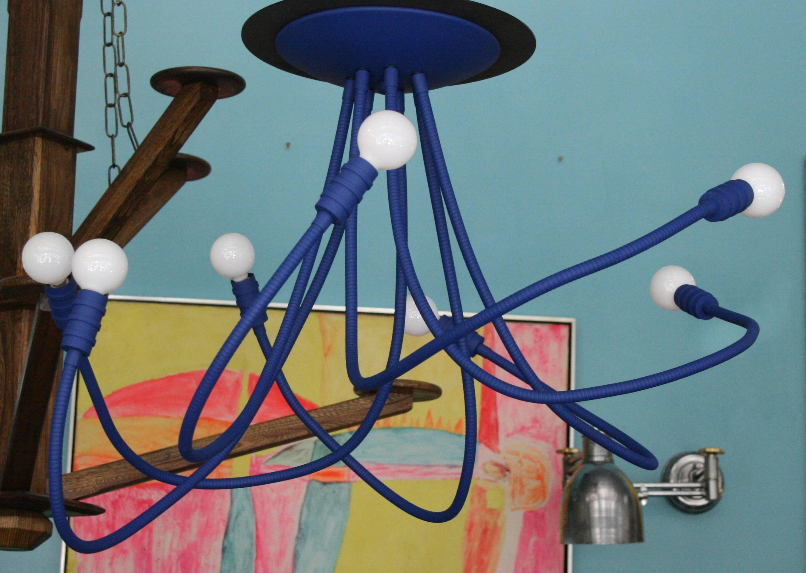 Ultramarine blue meander chandelier with seven flexible arms, ceiling mounted chandelier with endless poses; custom paint colors, or leather wrapping, and metal finish options available. Artisanal luxe lighting, designed and made in the USA. Each