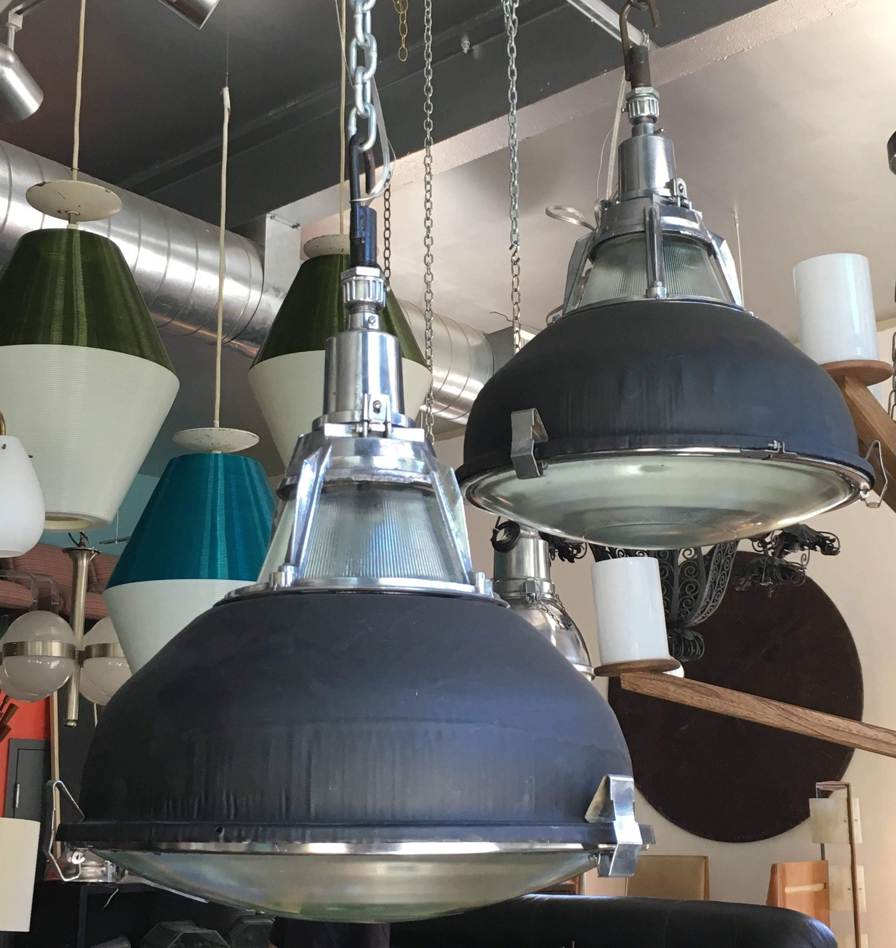 French industrial pendant lights each with two-piece of original glass; spun aluminum shade (shown in matte black) can be custom color.
Pair available.
Avantgarden Ltd. cultivates unexpected and exceptional lighting, furniture and design.  To view