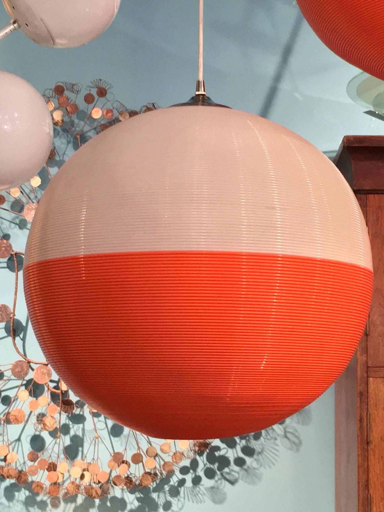 Pair of vintage Rotaflex globe lights, half with half orange, all new wiring, designed by Heifetz.