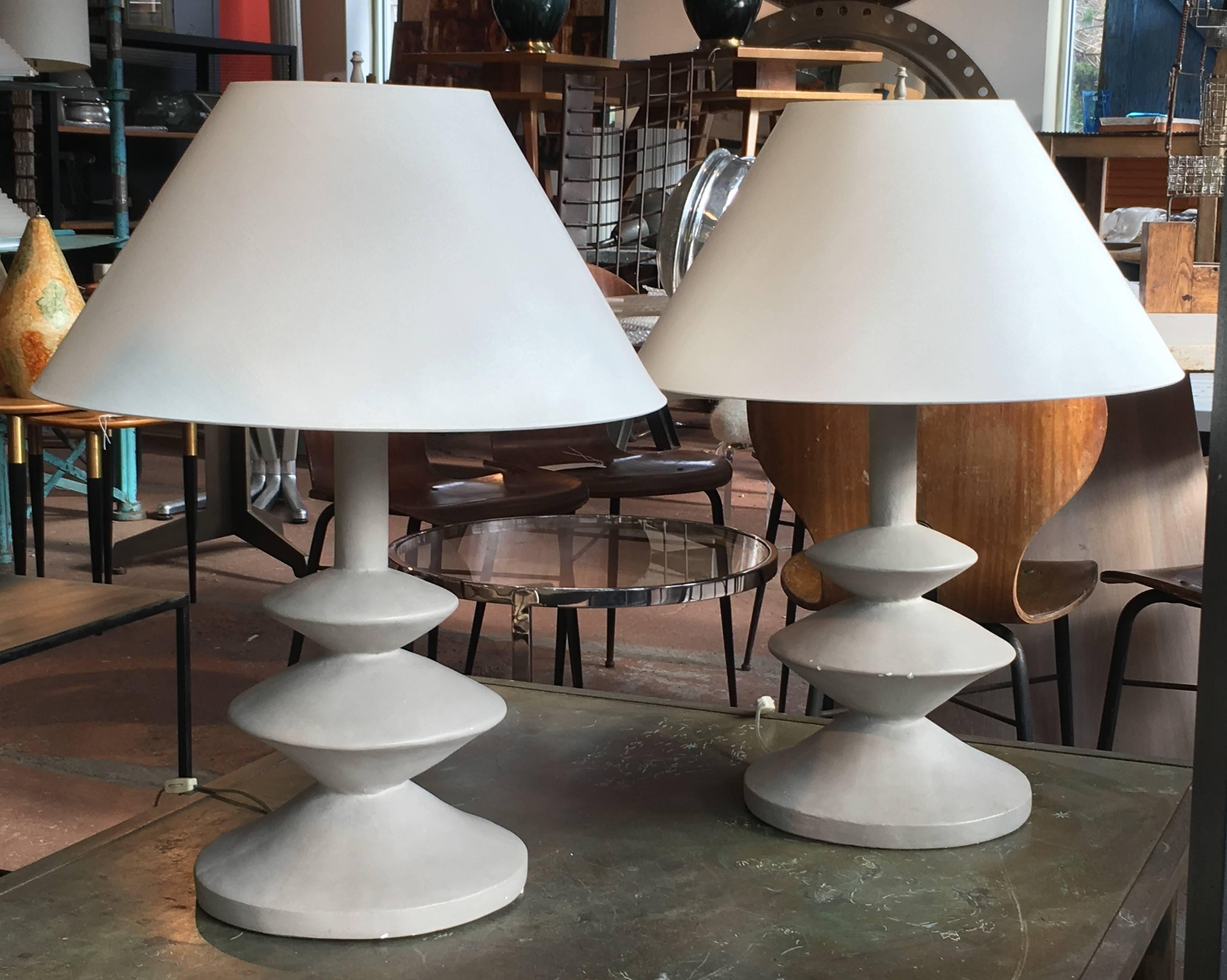 Original pair of plaster lamps by Jacques Granges for Yves Saint Laurent, inspired by Giacometti's 1930s model made for Jean Michel Frank. Rare gray putty color; original condition, a few surface nicks to finish. Original shades are included but new