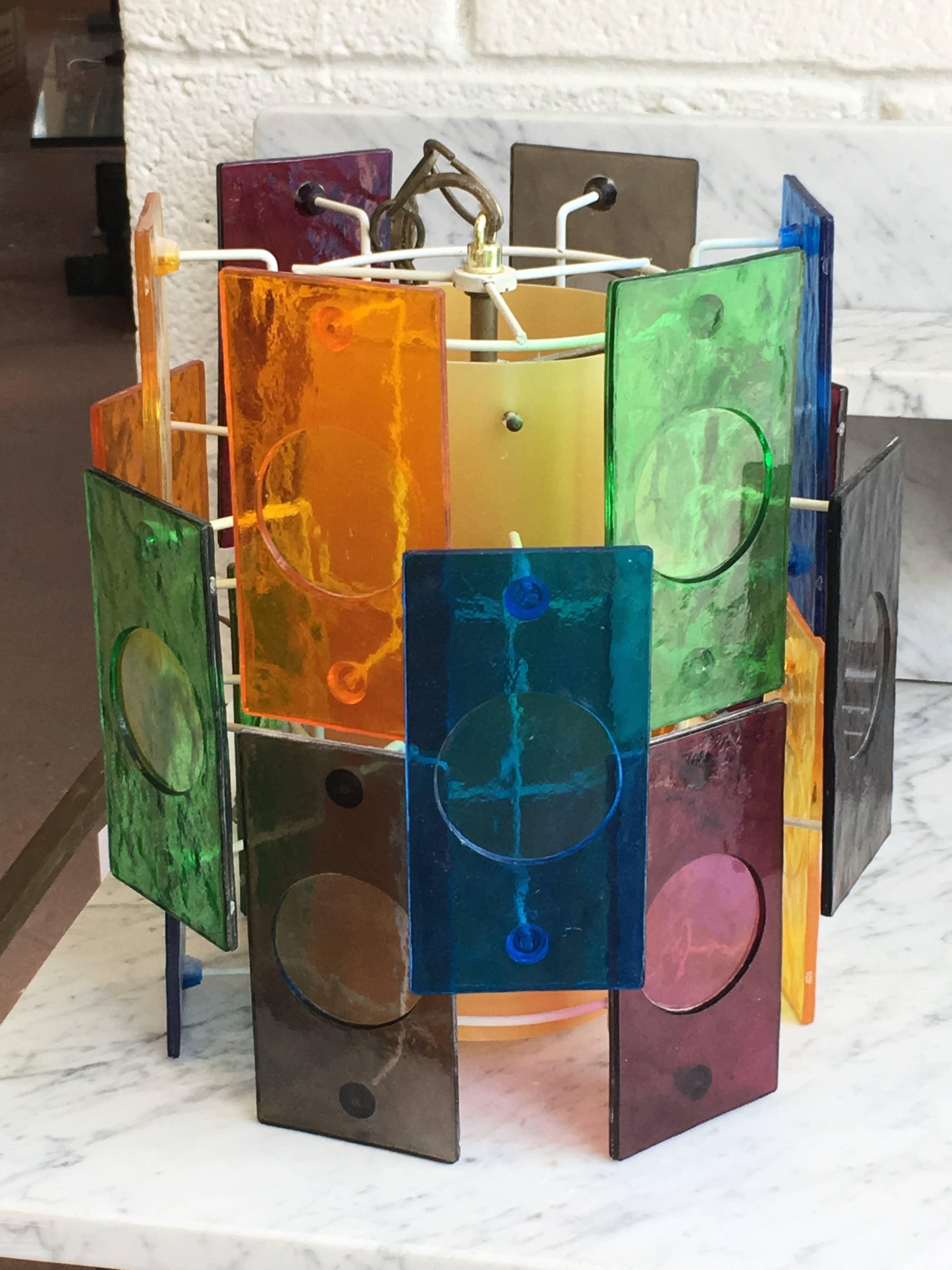 Mid-Century multicolored cylindrical hanging light with colored plastic facets and an interior cylinder, single Edison socket, all new wiring; we can provide chain and canopy to your specs, ready to hang.
Avantgarden Ltd. cultivates unexpected and