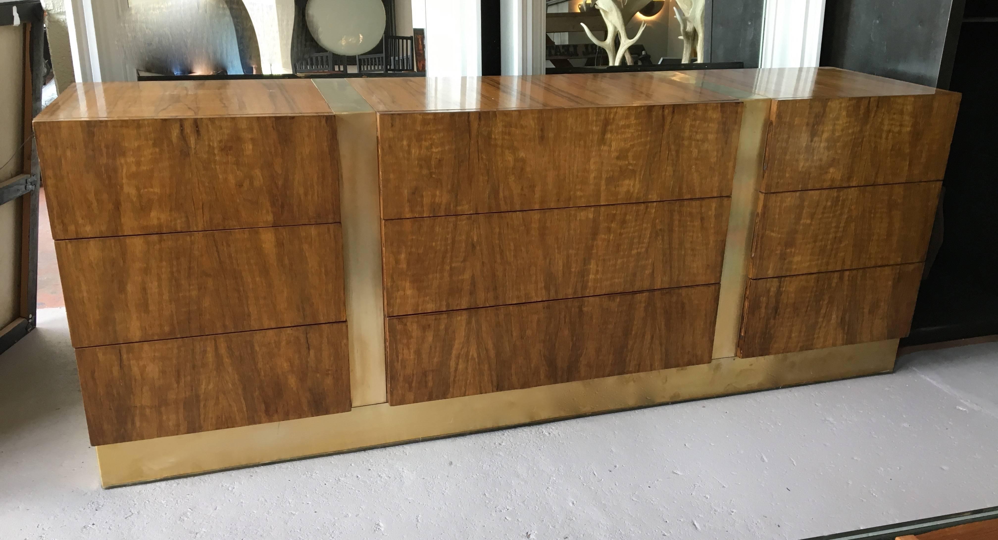 Versatile rosewood credenza with brass banding, featuring all drawers; a total of nine drawers, retaining original maker label.

Avantgarden Ltd. cultivates unexpected and exceptional lighting, furniture and design. To view items in person please