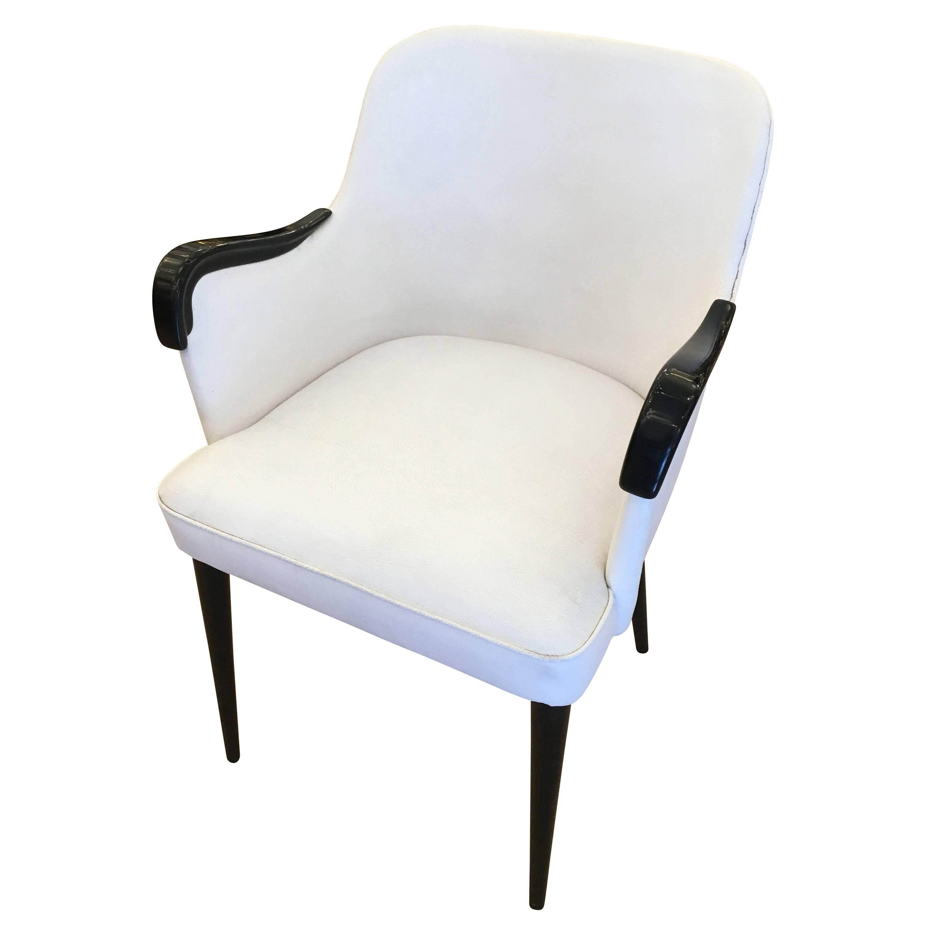 Set of four timeless armchairs by Osvaldo Borsani for Tecno. Great for dining or as desk chairs. Sold as is with original white vinyl fabric. Legs are wood. Can be sold individually.

Condition: Vintage condition with original fabric

Measure: Width