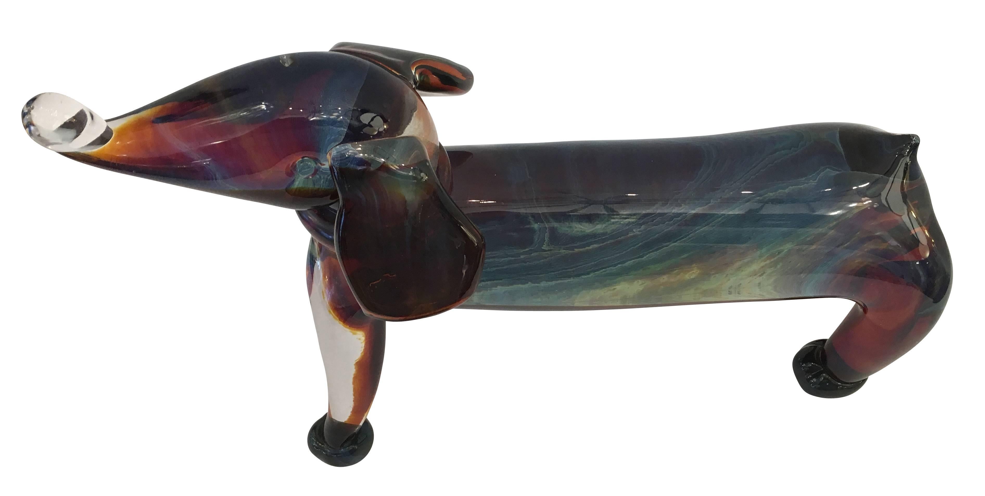 Playful handblown Murano glass dog sculpture from the 1960s. Made in the “Sommerso” technique allowing the color to change depending on the viewing angle.

Available for viewing at Gaspare Asaro-Italian Modern in NYC