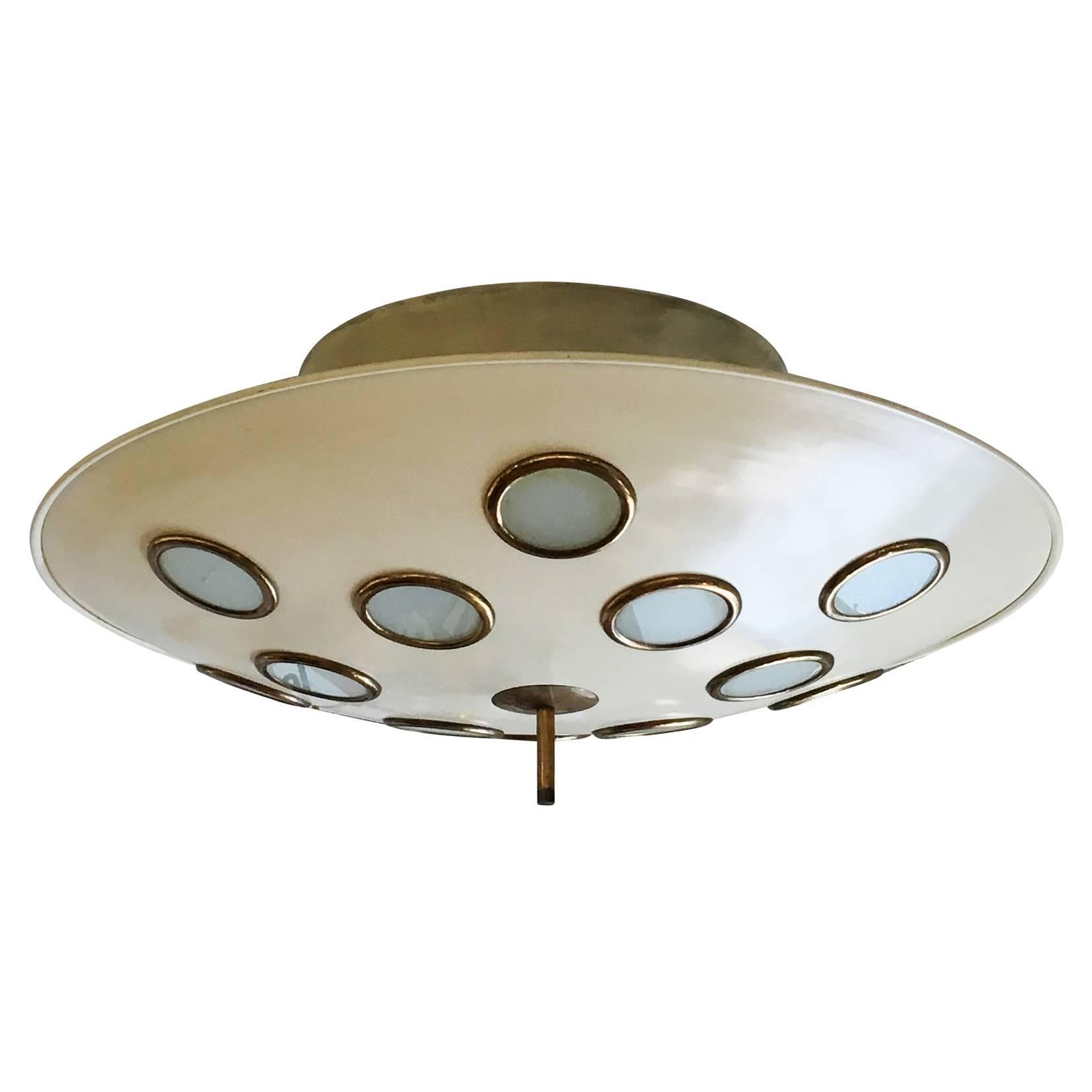 Imposing saucer shaped chandelier attributed to Arredoluce featuring twelve frosted glass lenses. The large conical stem, holds six regular sockets creating diffused light through the glasses as well as on the ceiling. Glass rims and finial are