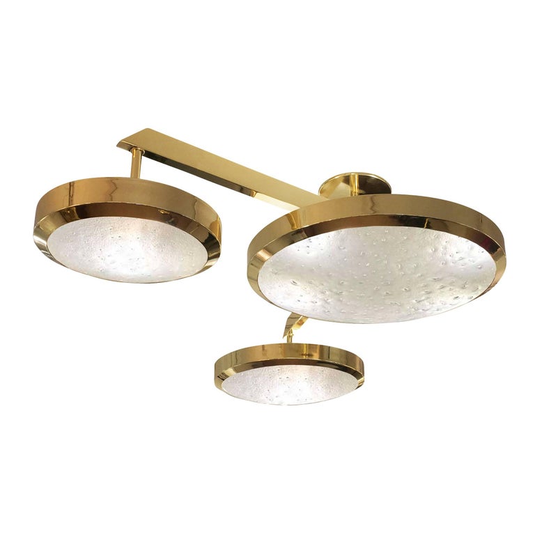 The Zeta ceiling light features a composition of variable sized Murano glass shades methodically balanced on a “V” shaped brass frame. Shown in the bronzo ottone finish with our signature Murano bubble glass. Price shown for stock model in polished